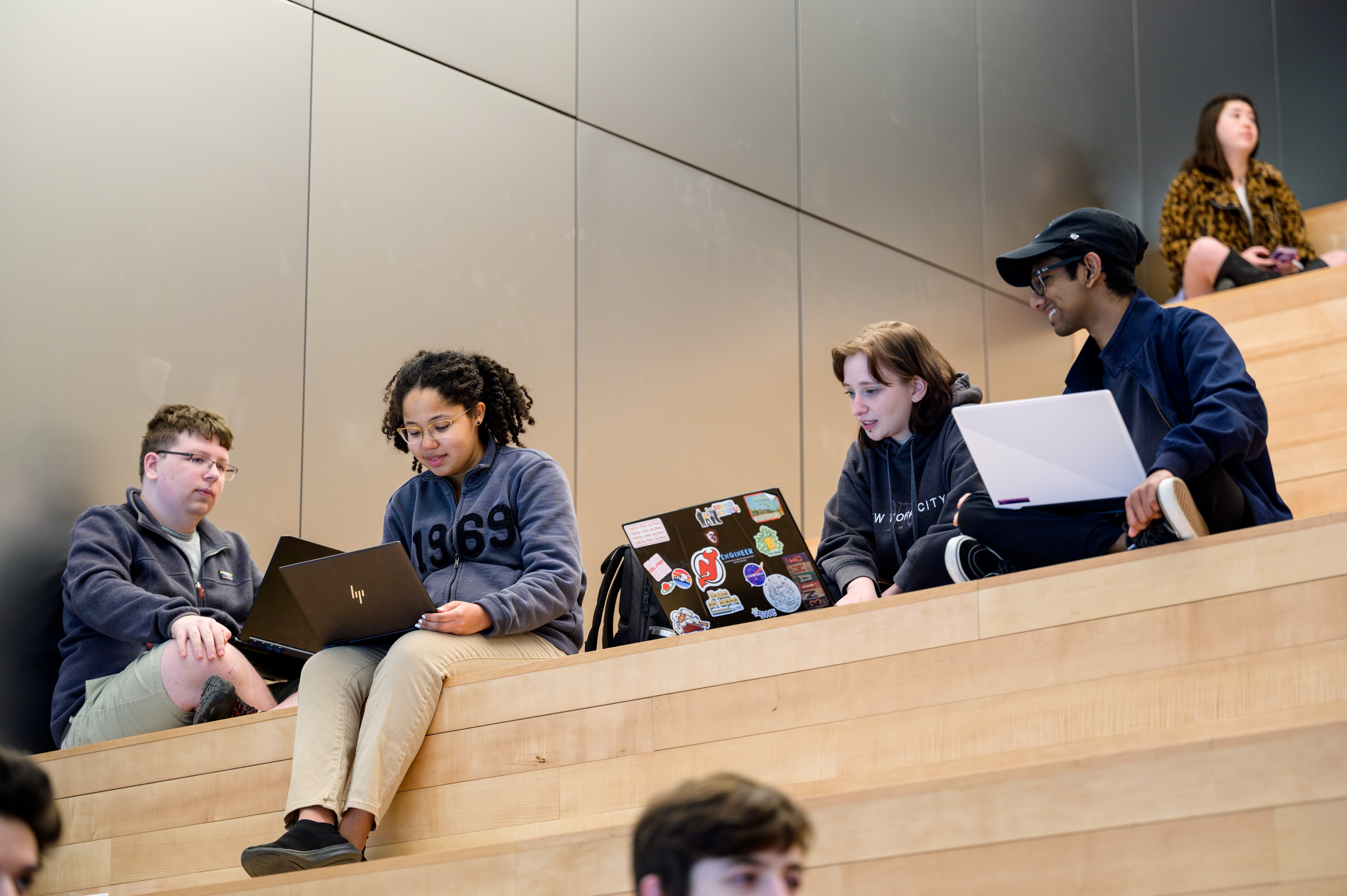 Students sit on the steps in Gateway, working and studying together, at Stevens Institute of Technology