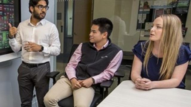 Students reviewing a stock chart