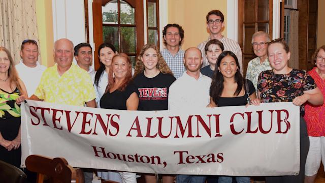 Alumni and students gather at a new student send-off event with a Stevens Alumni Club Houston Texas banner