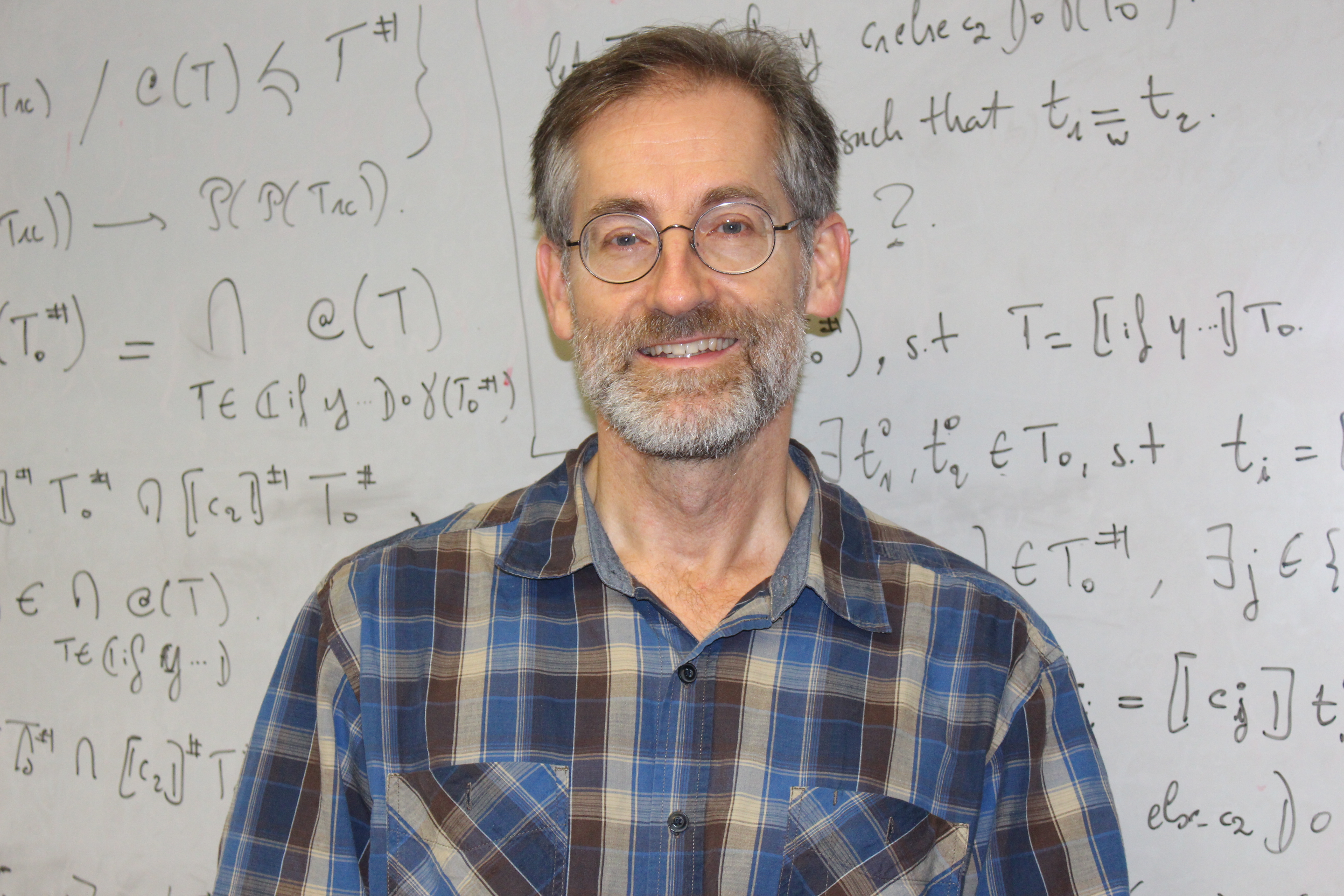 Computer Science Department Chair Dave Naumann in front of whiteboard