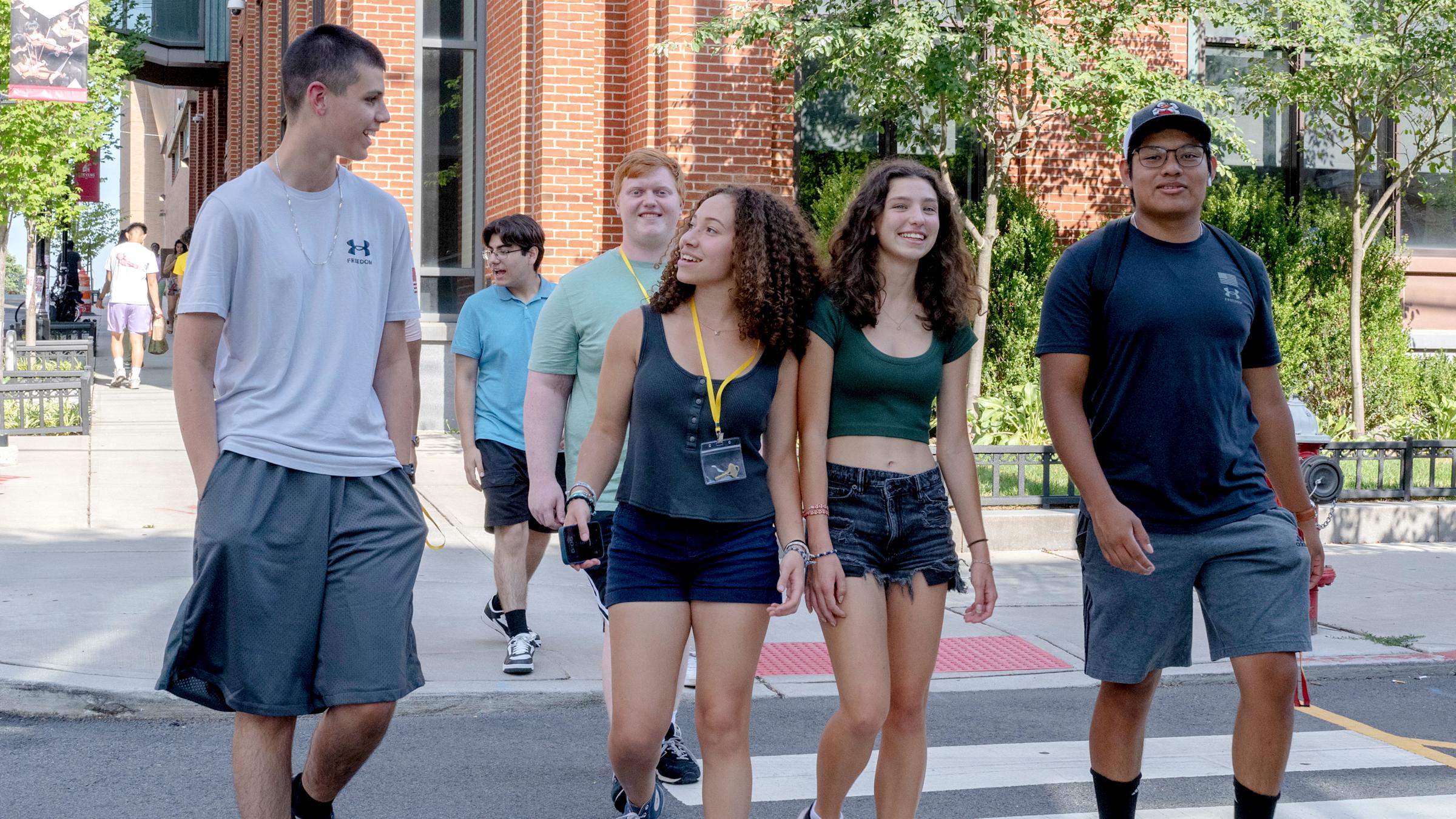 Mix of pre-college students walking on campus