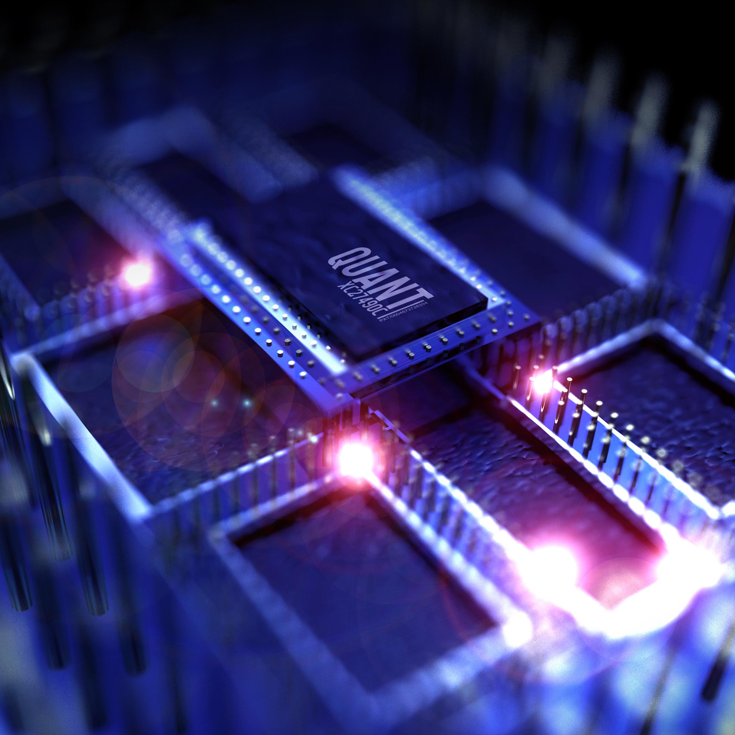 Computer chips in purple light with "Quant" printed on chip