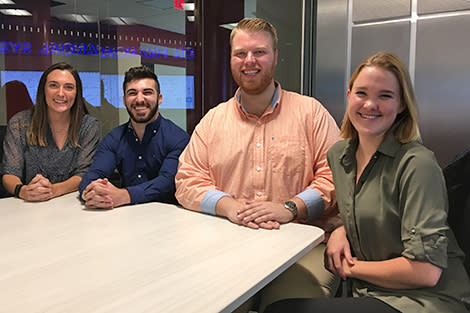 Four students collaborate in the high-tech Hanlon Lab.