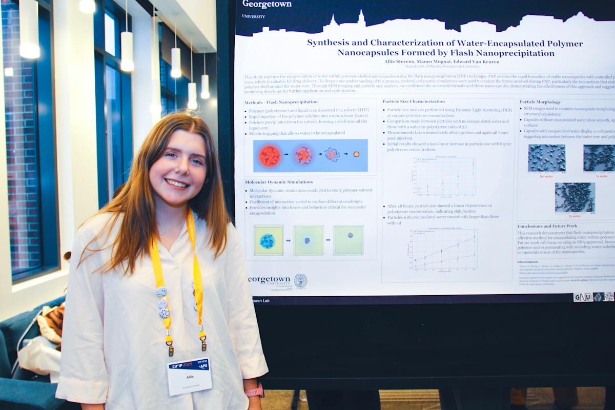 A student smiling and standing in front of a poster presentation at CUWIP. 