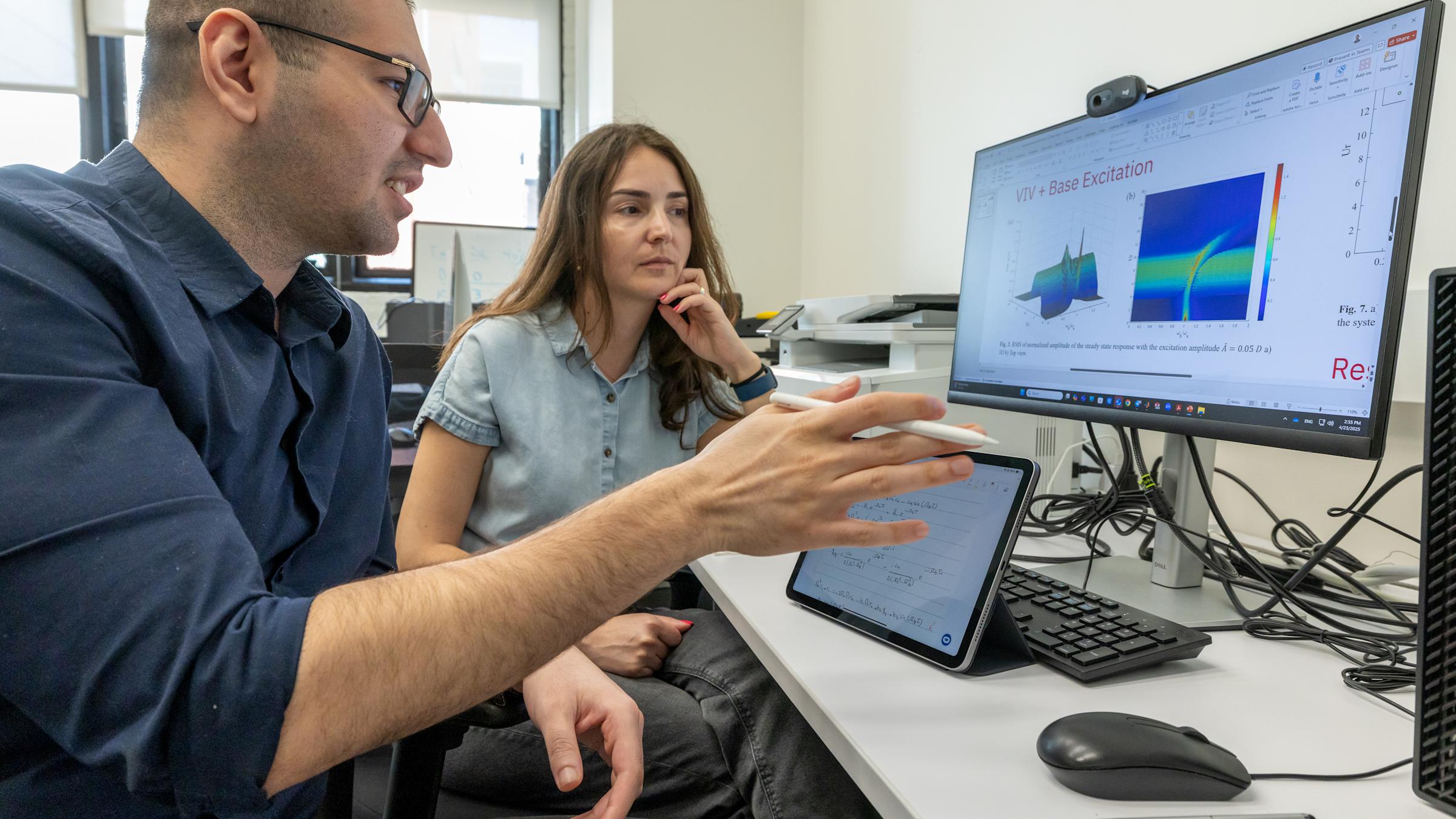 Gizem Acar working with a student in Carnegie Lab.