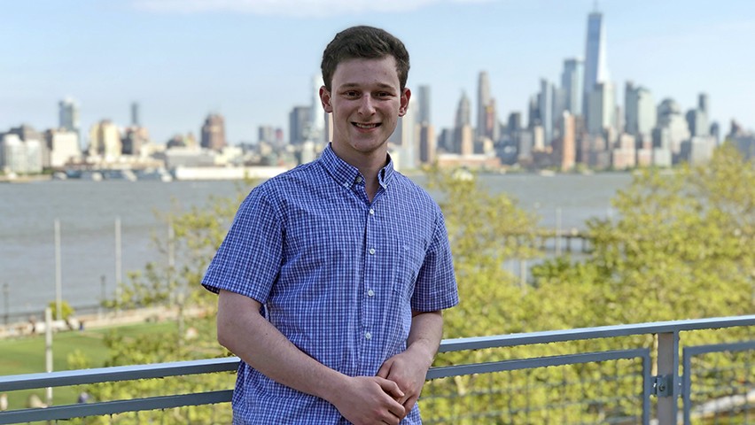 Daniel Gulko on the patio off the Babbio Center, with Lower Manhattan in the background.