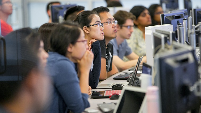 Graduate students watching a software demonstration in one of the data visualization labs at Stevens.