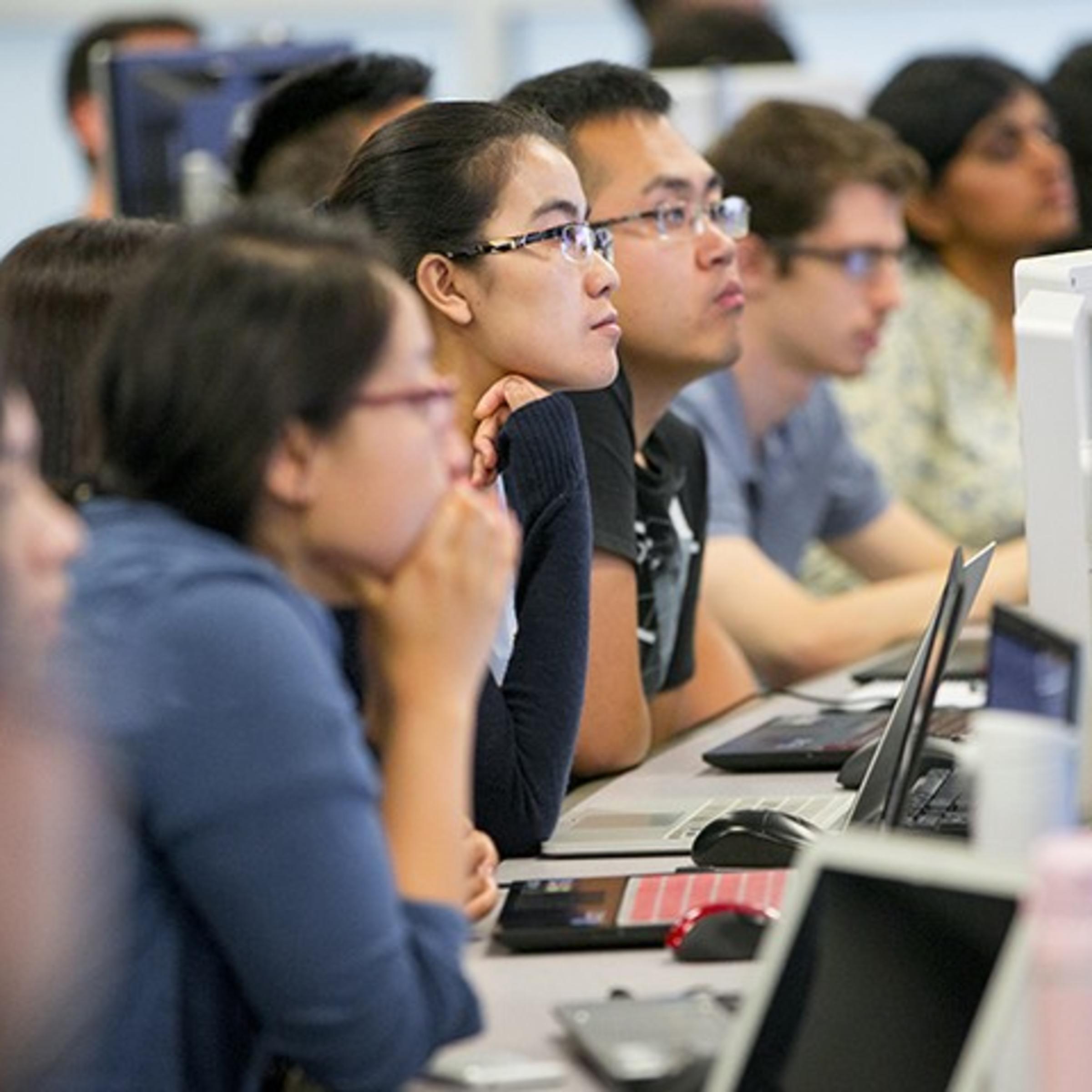 Graduate students watching a software demonstration in one of the data visualization labs at Stevens.
