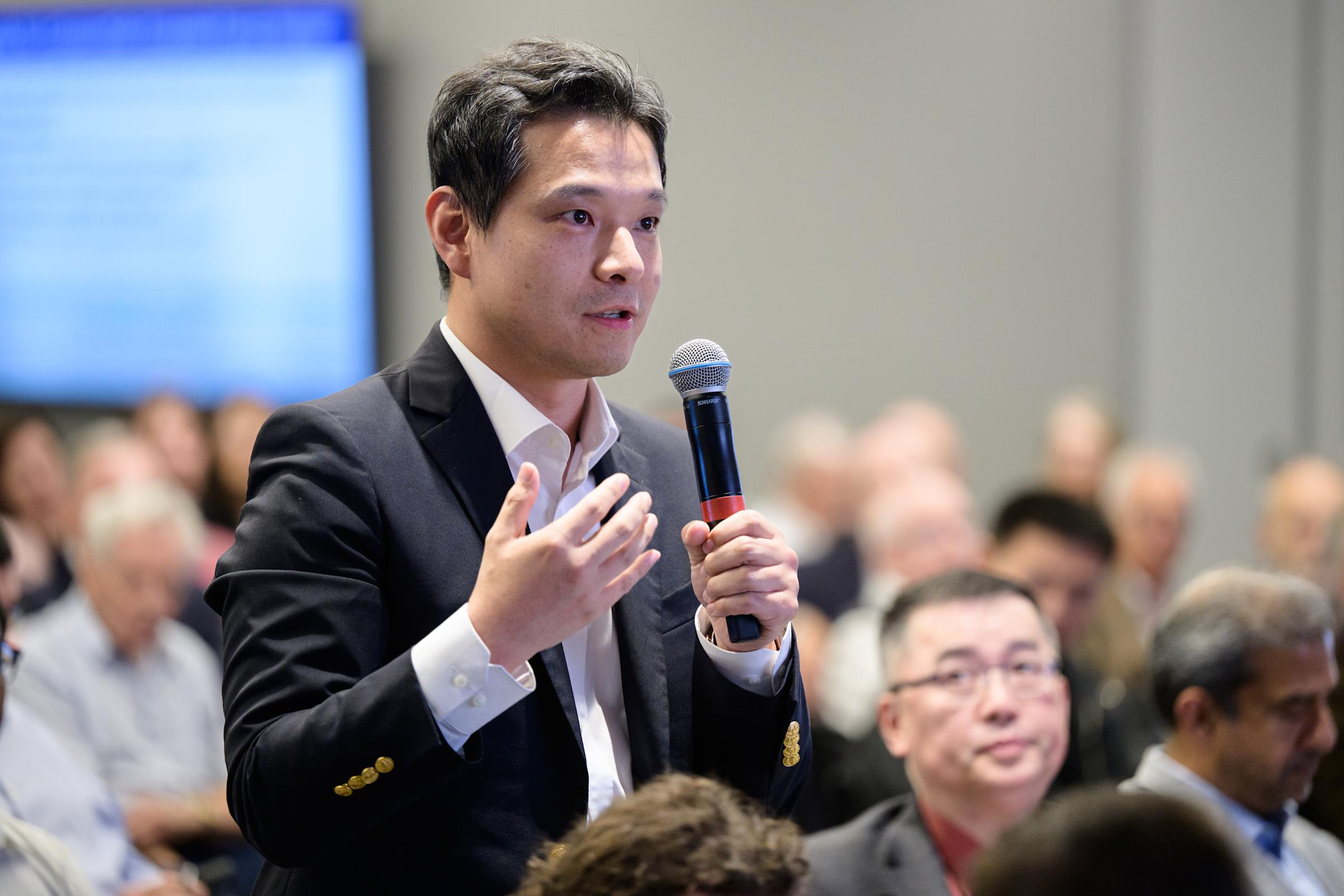 An audience member poses a question during Nobel Laureate M. Stanley Whittingham's lecture on the future of energy storage