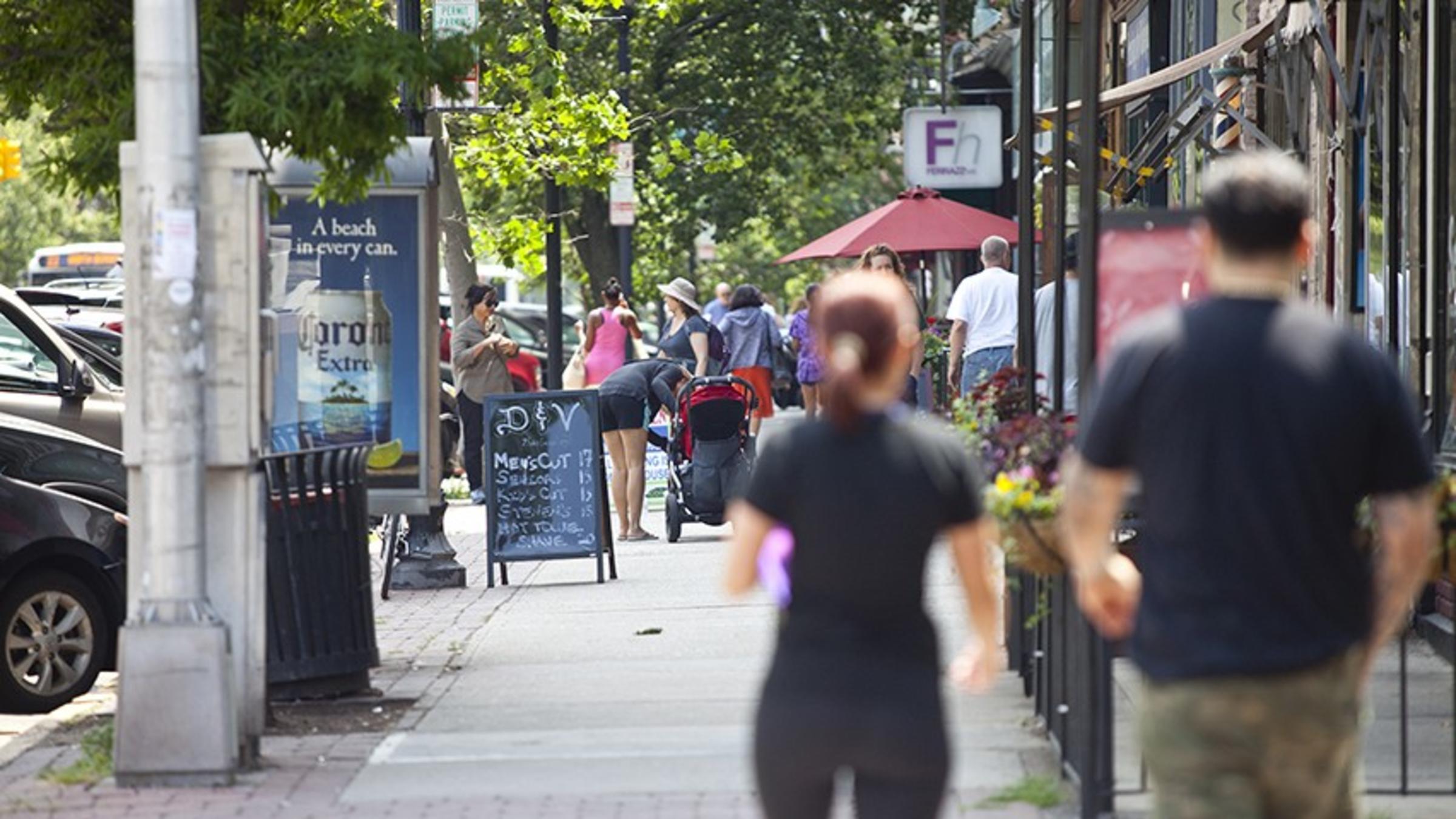 Pedestrians walk along the businesses of Washington Street, in Hoboken.