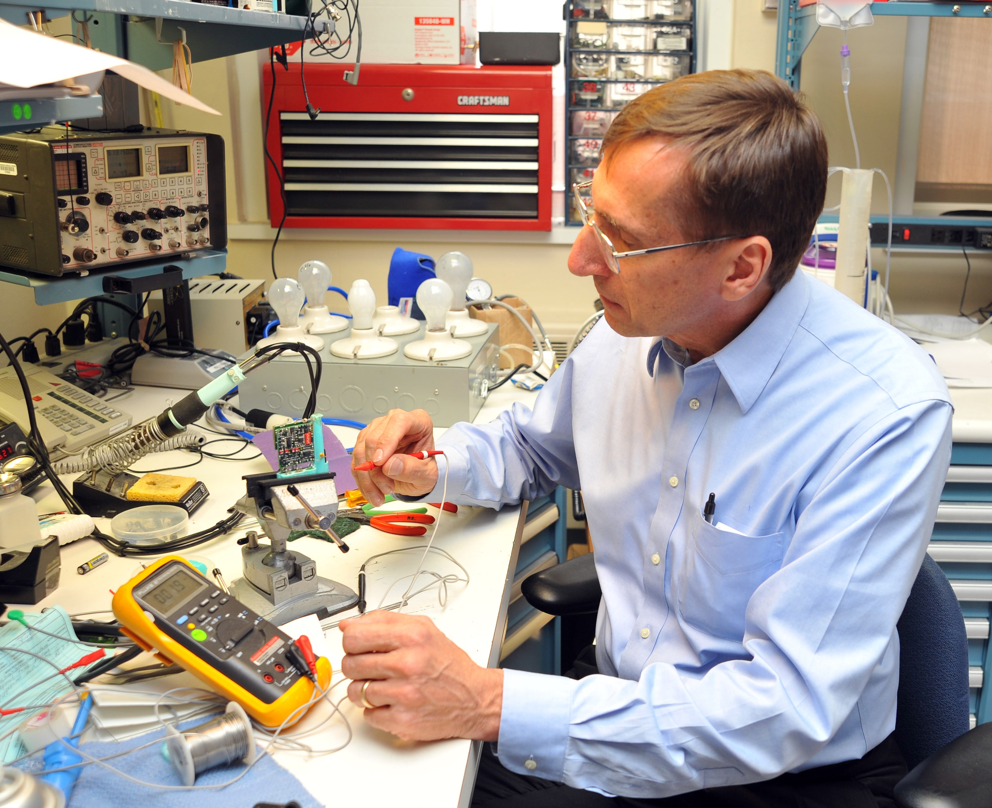 Herman Morchel M.Eng. '80 working with biomedical equipment in the lab at Hackensack University Medical Center