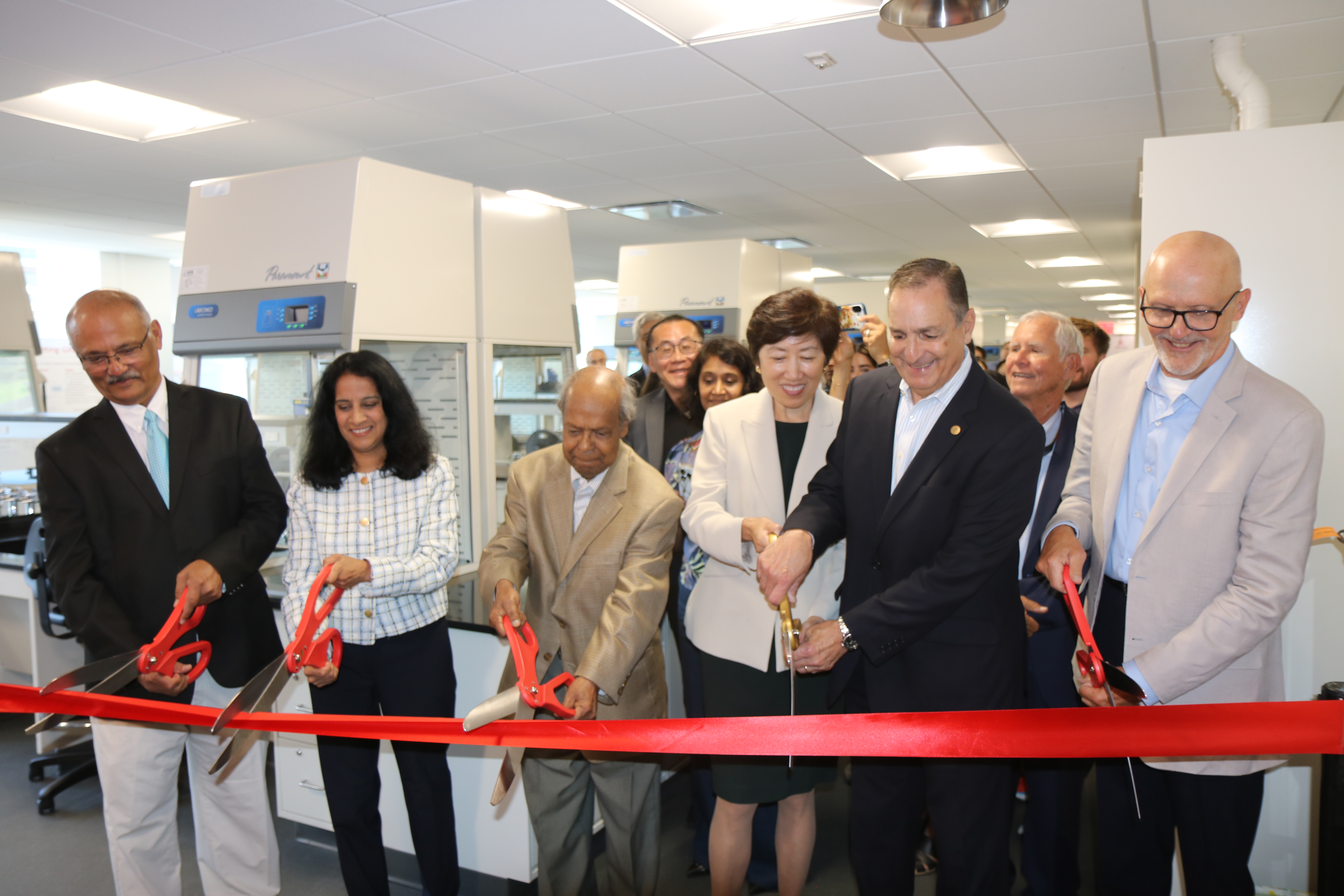From left to right: Arvind Mathur, Sesha Sridevi Alluri, Birendra Pramanik, Jean Zu, Robert Maffia, and Jeffrey Hale cutting a ribbon to symbolize the reopening of the Department of Chemistry and Chemical Biology's organic chemistry lab.