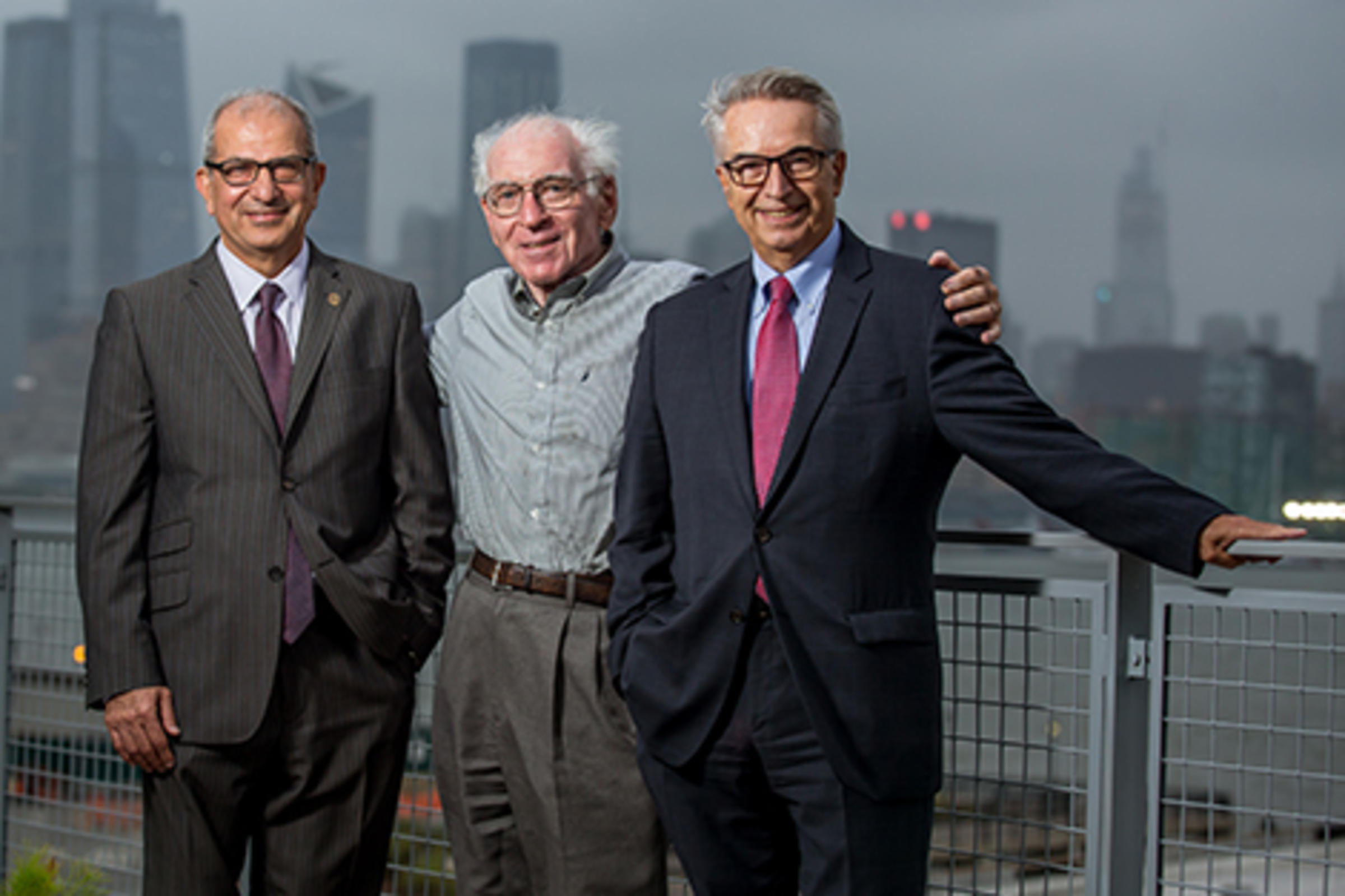 Three men in front of Manhattan.