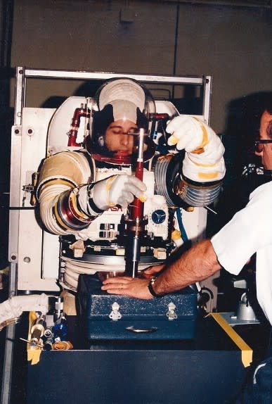 Paul Porzio ’77 wears a NASA space suit while conducting an experiment in 1984