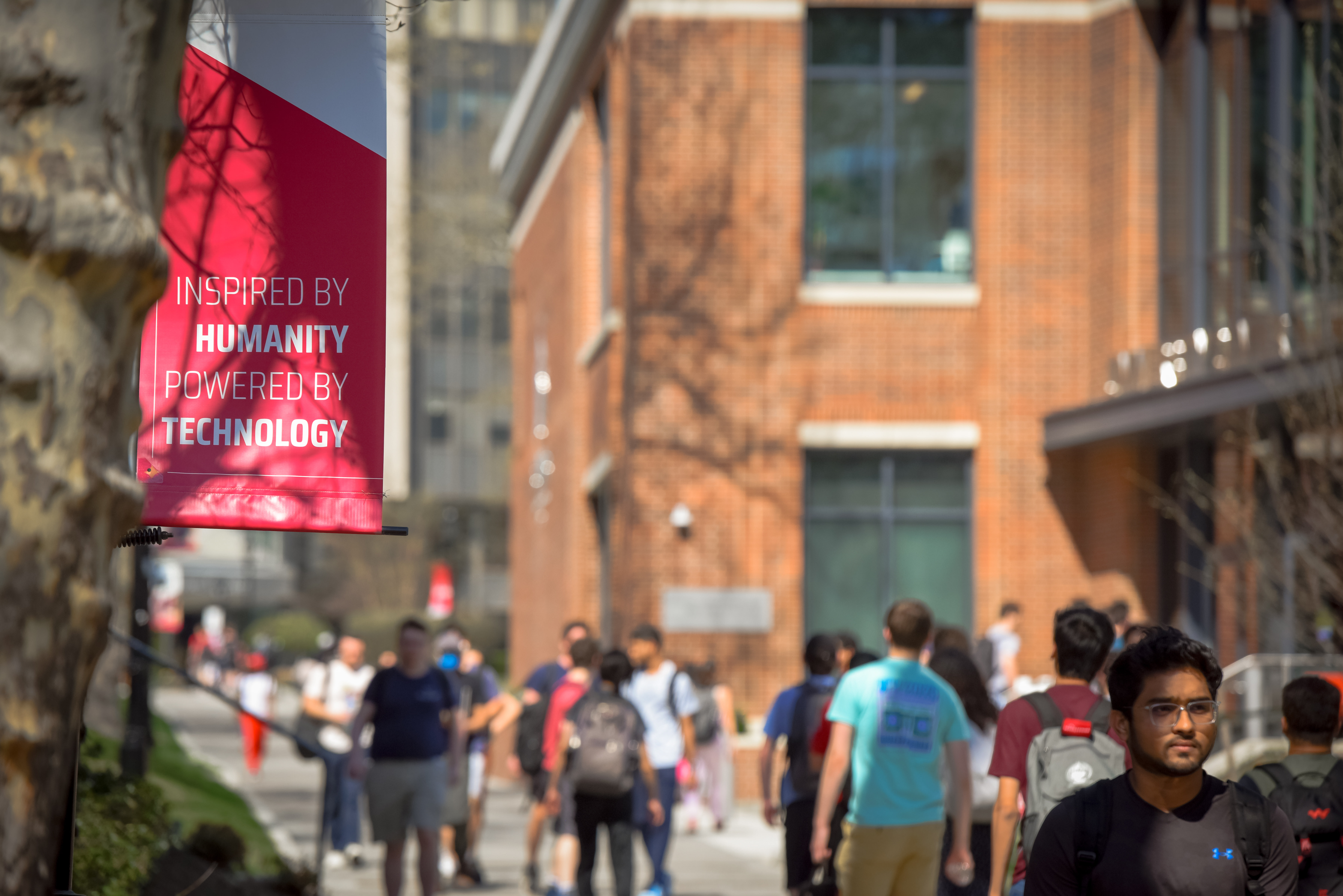 A flag that reads 'Inspired by Humanity, Powered by Technology'