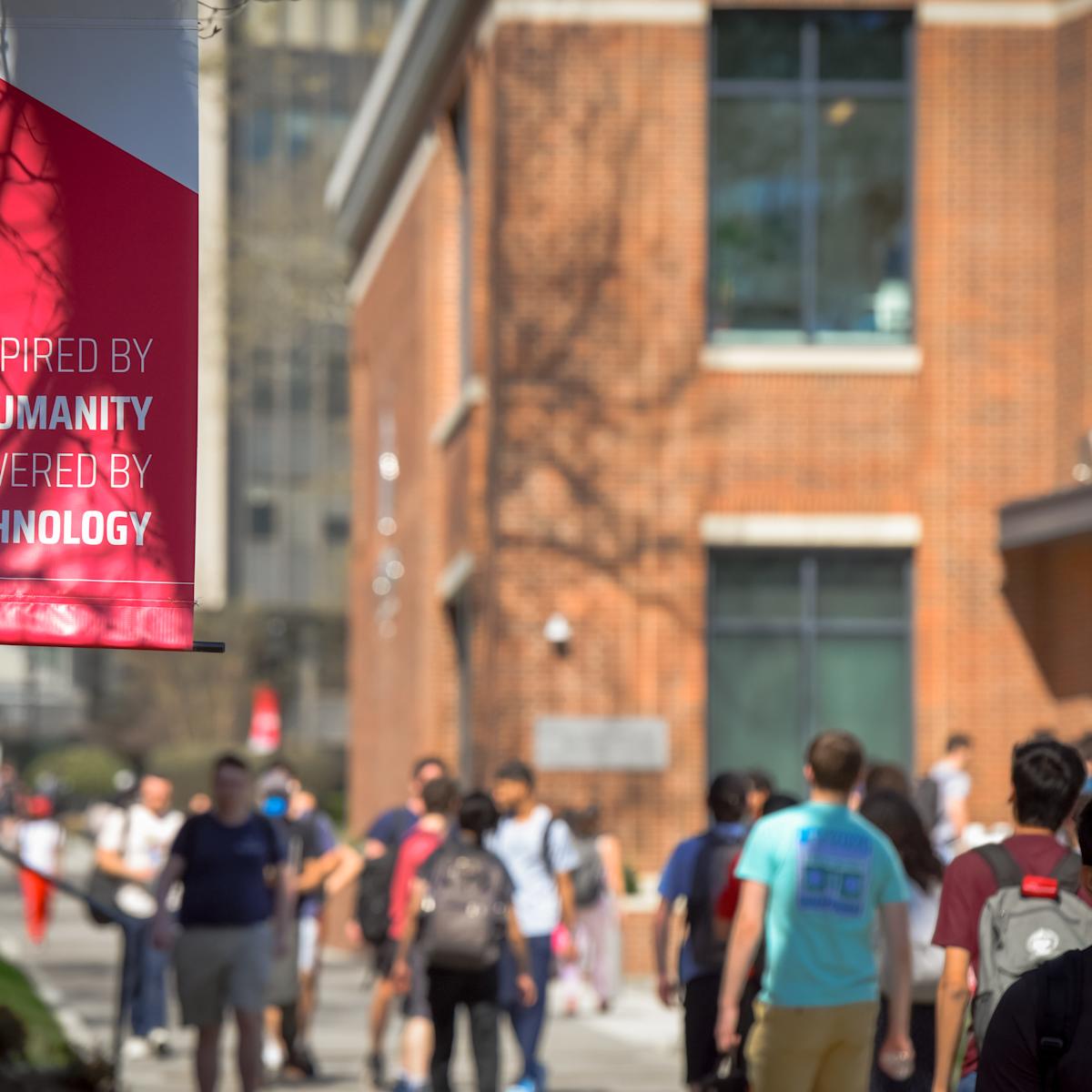 A flag that reads 'Inspired by Humanity, Powered by Technology'