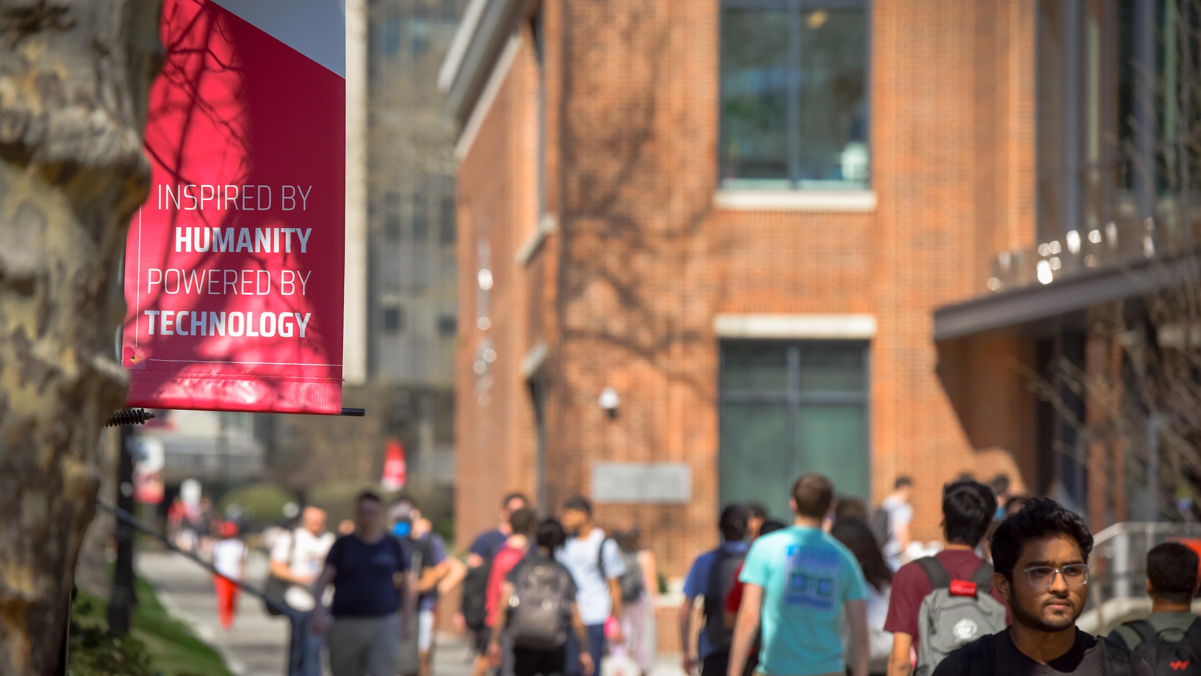A flag that reads 'Inspired by Humanity, Powered by Technology'