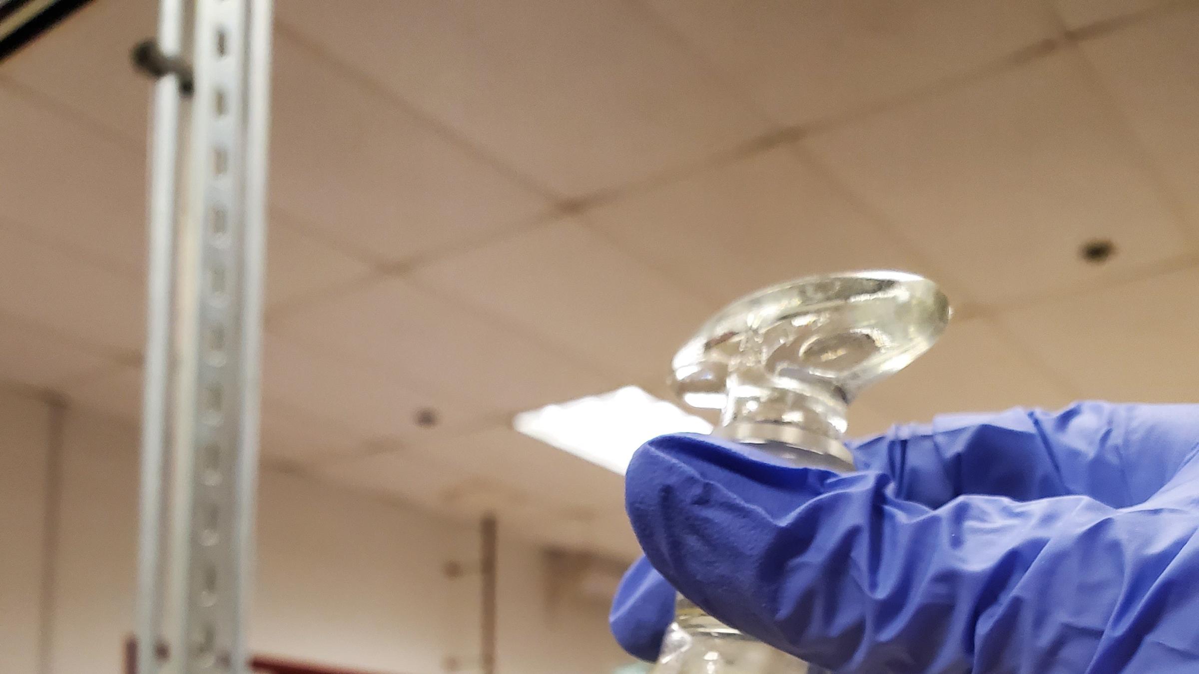 Hands holding flask in lab