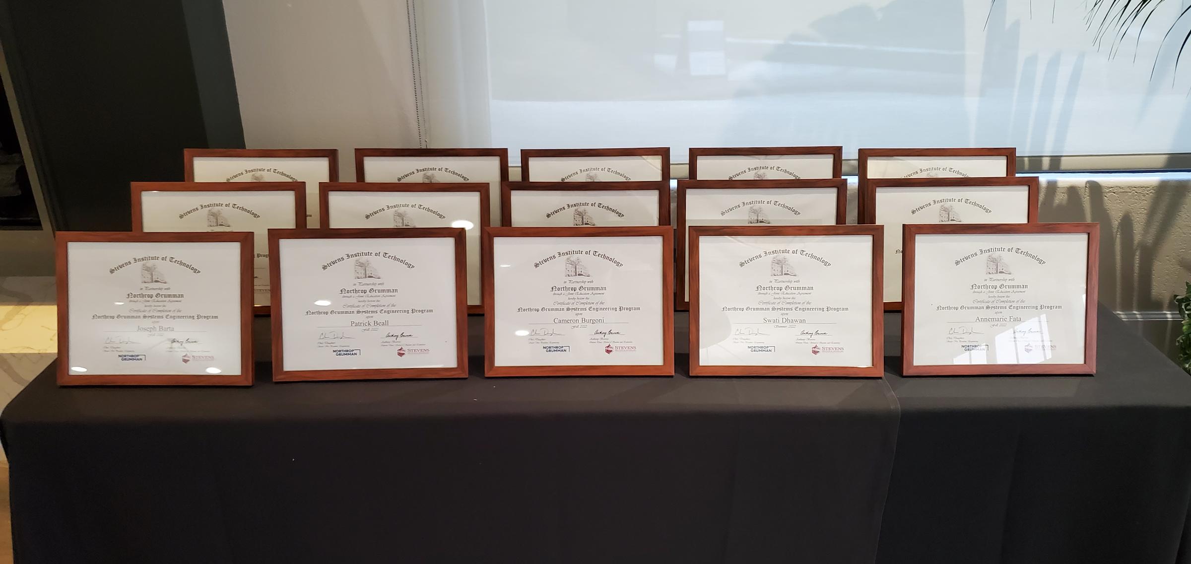 Systems Engineering masters degrees framed on a table.