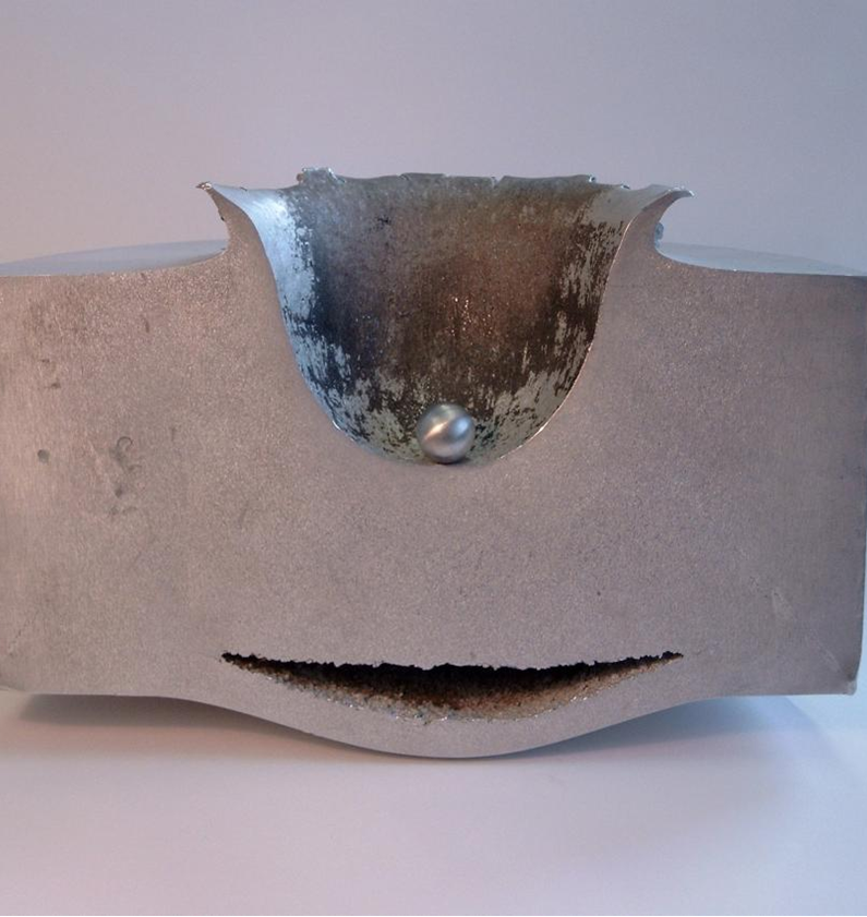 This image shows the results of a lab test impact between a small sphere of aluminum travelling at approximately 6.8 km/second and a block of aluminum 18 cm thick.