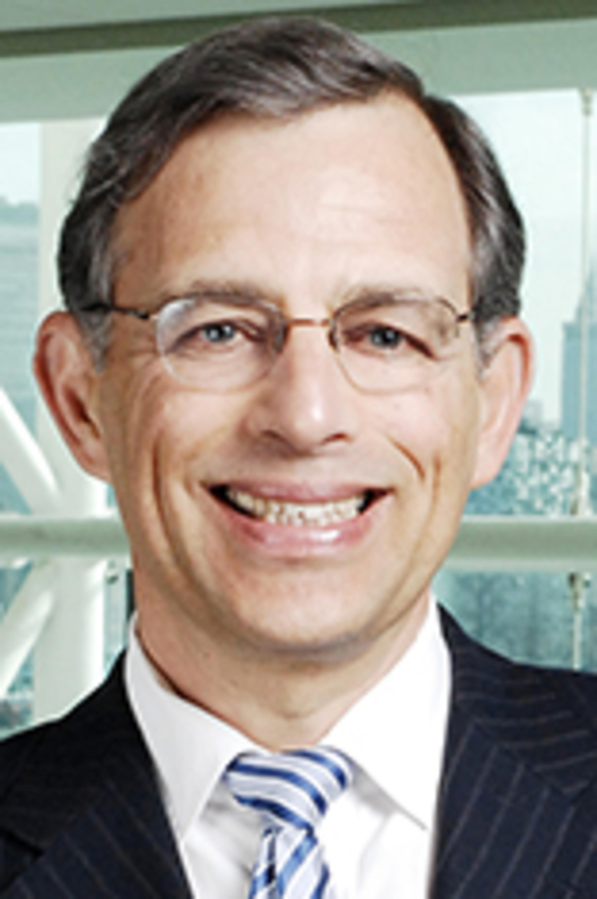 Headshot of Dr. Zvi Aronson with the New York skyline in the background.