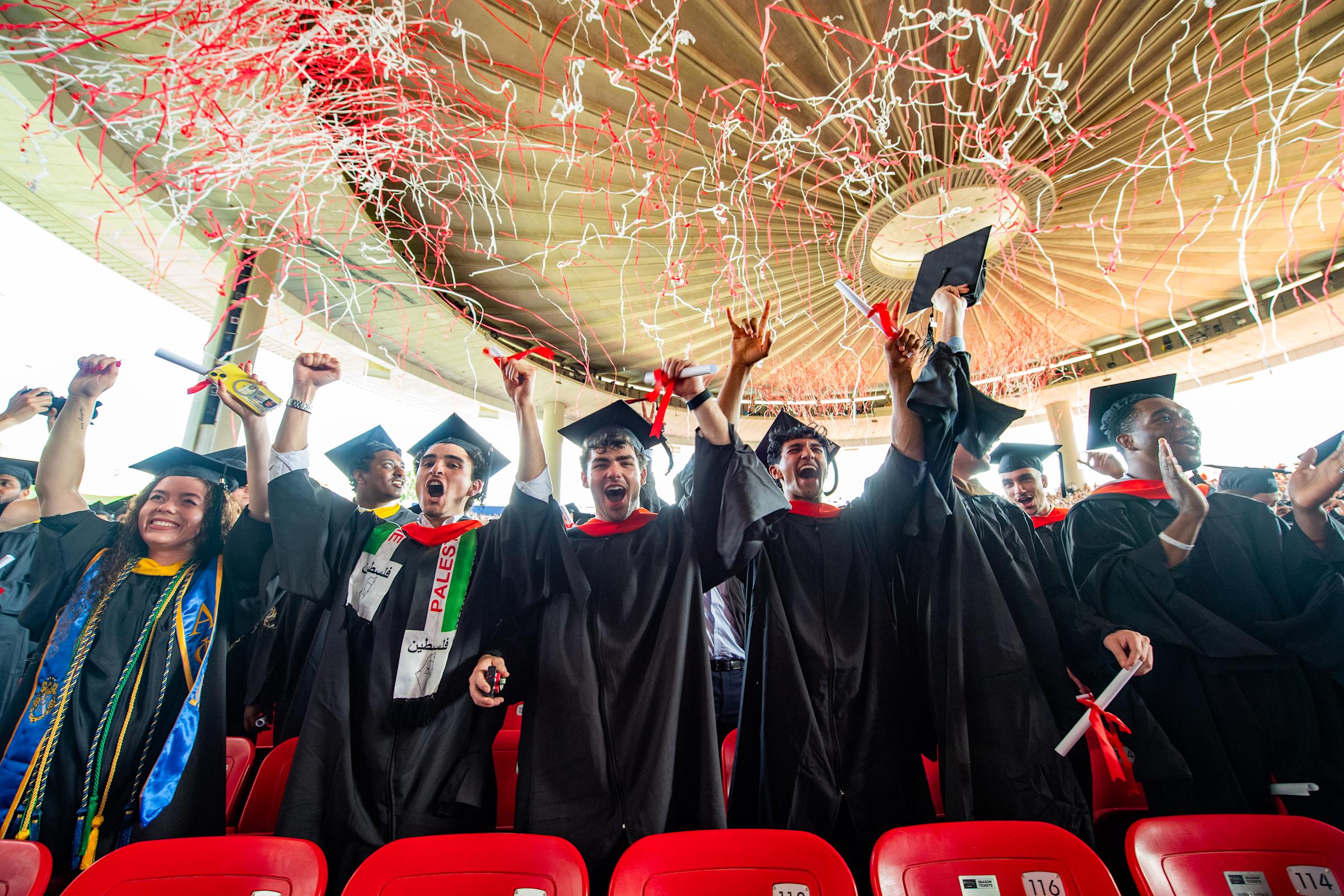 Graduates celebrate under confetti