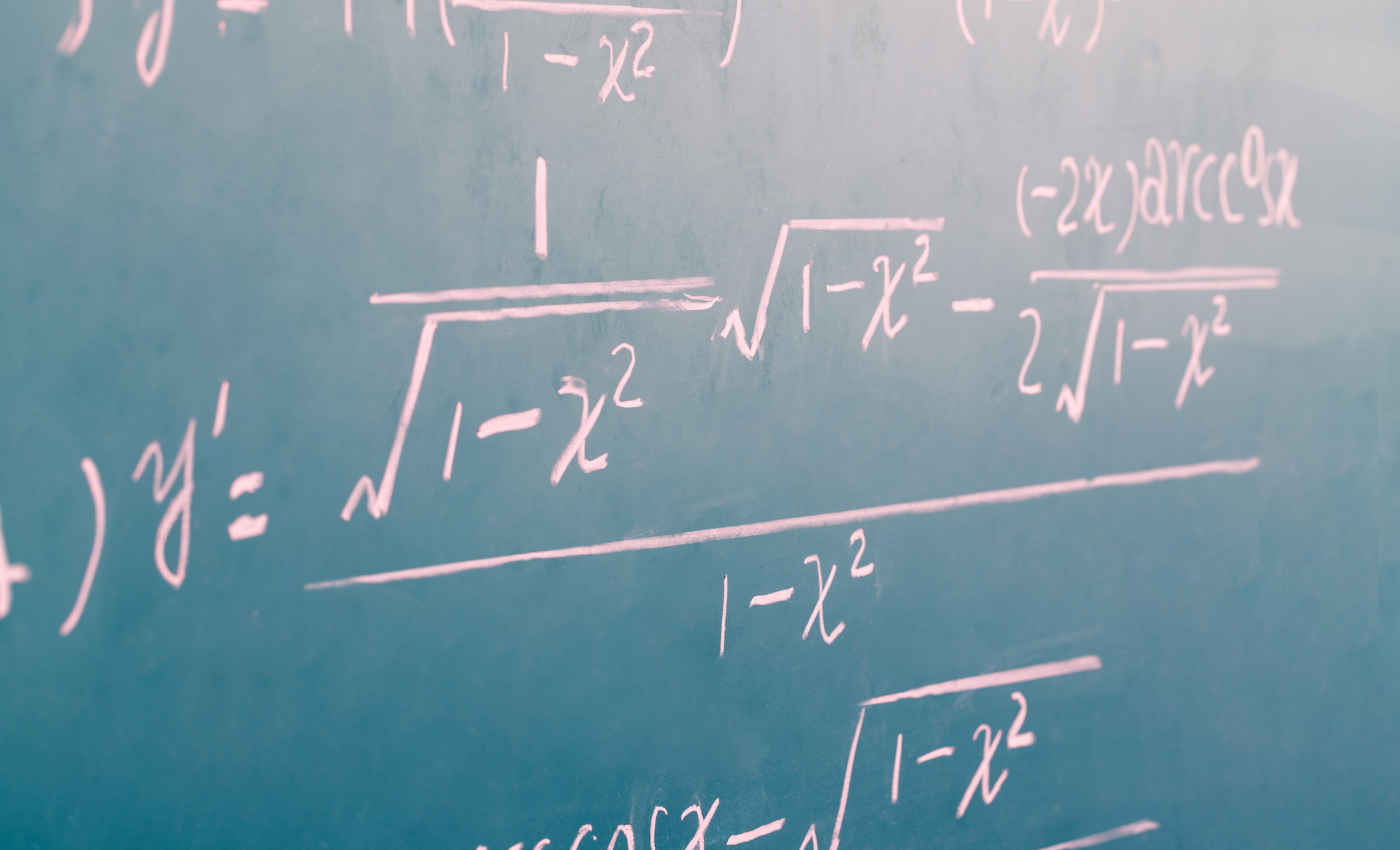 complex math equations written on a chalkboard