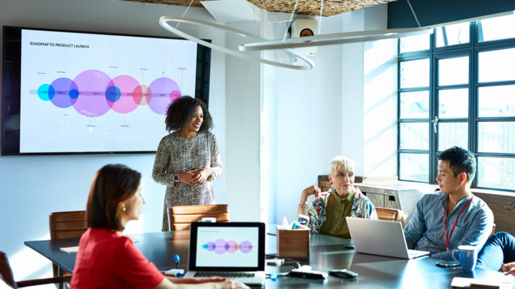 four people in a conference room