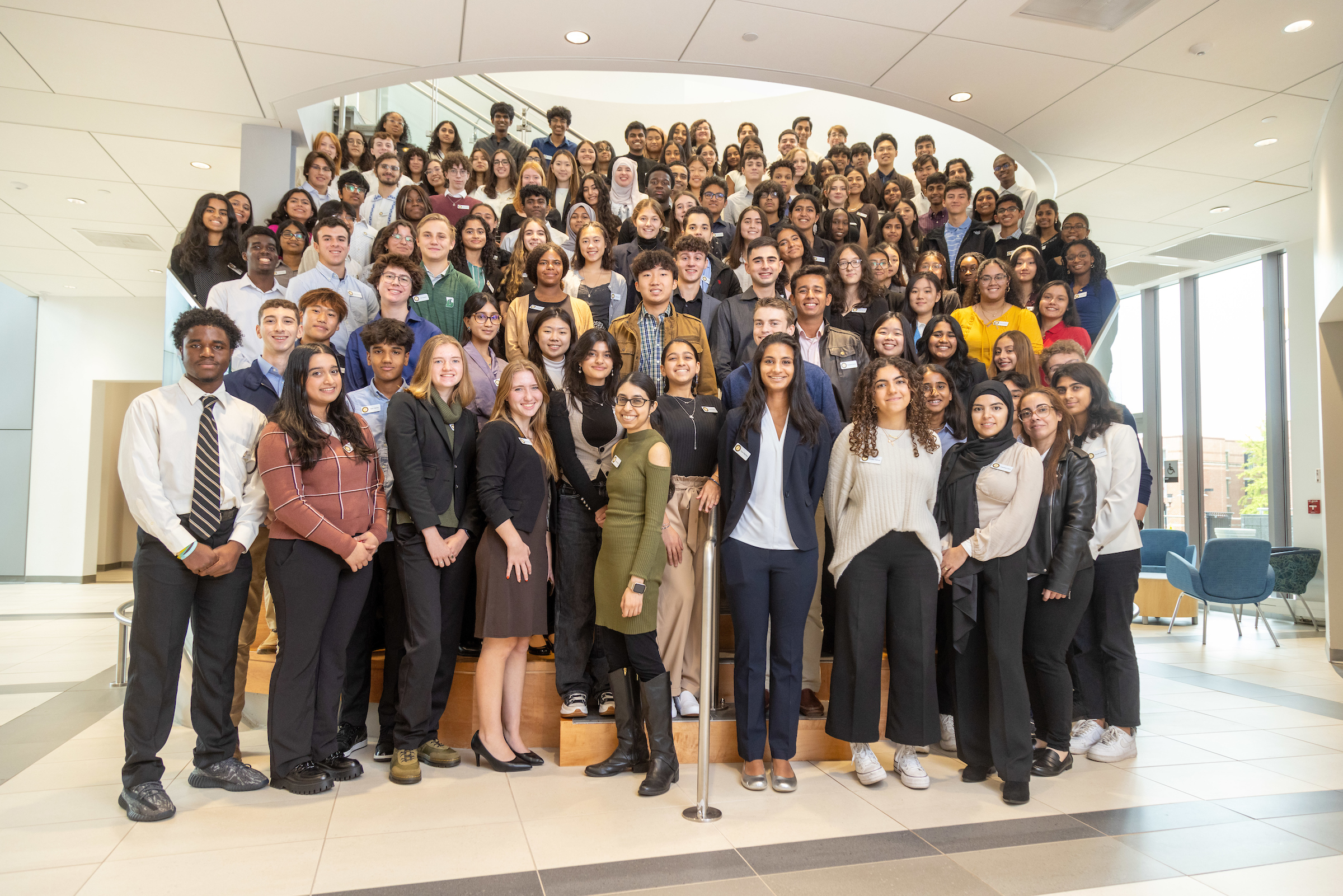 Large group of students standing in rows in on a staircase.