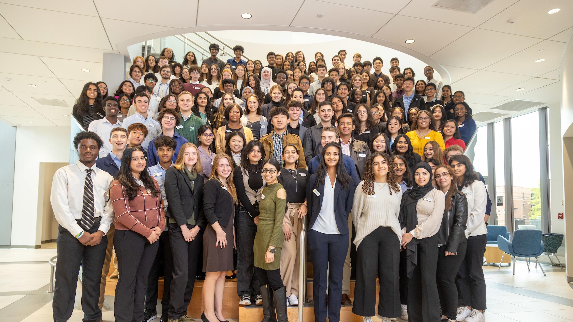 Large group of students standing in rows in on a staircase.