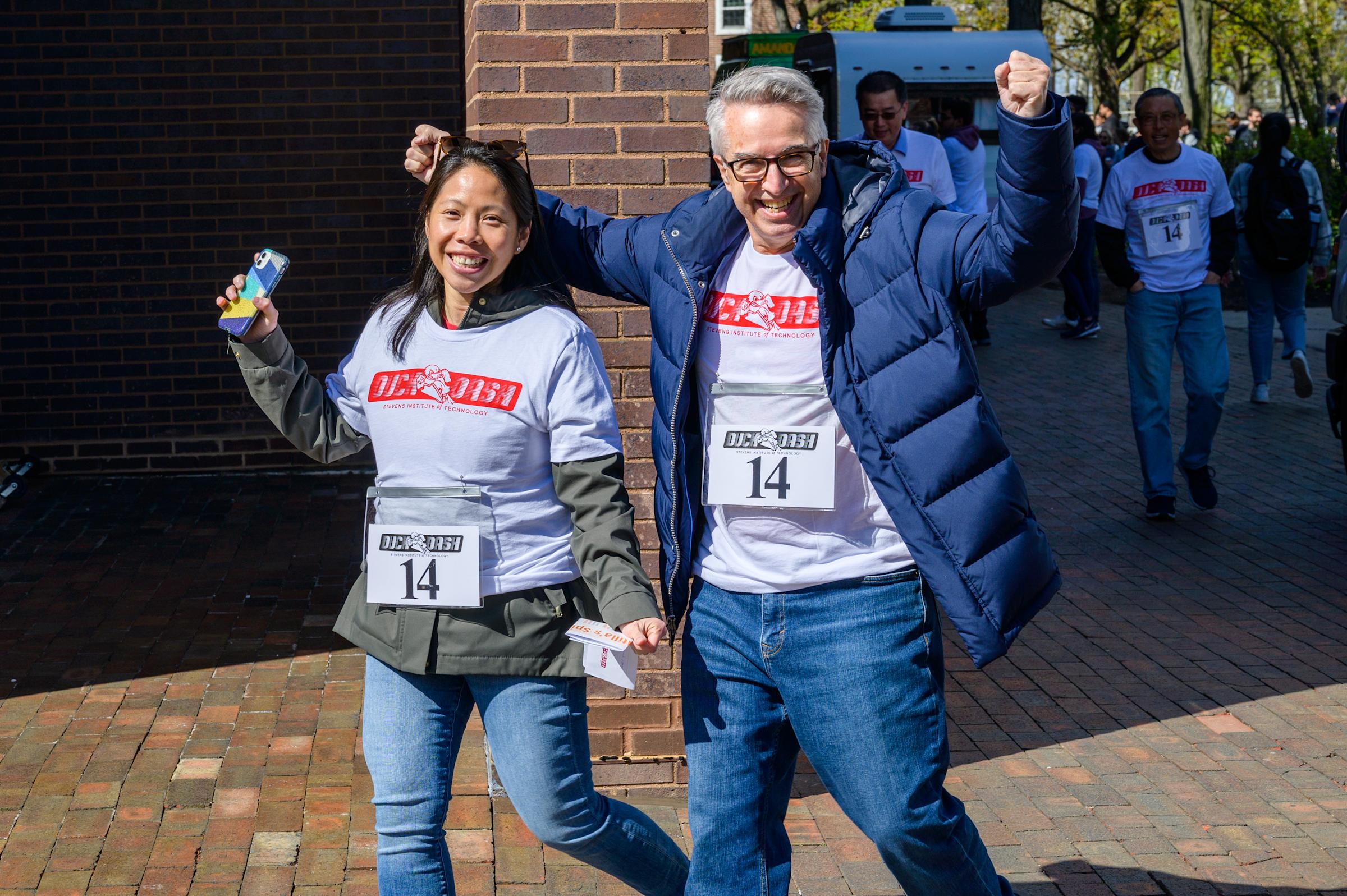 Dr. Cindy Chin celebrating as she runs with a colleague