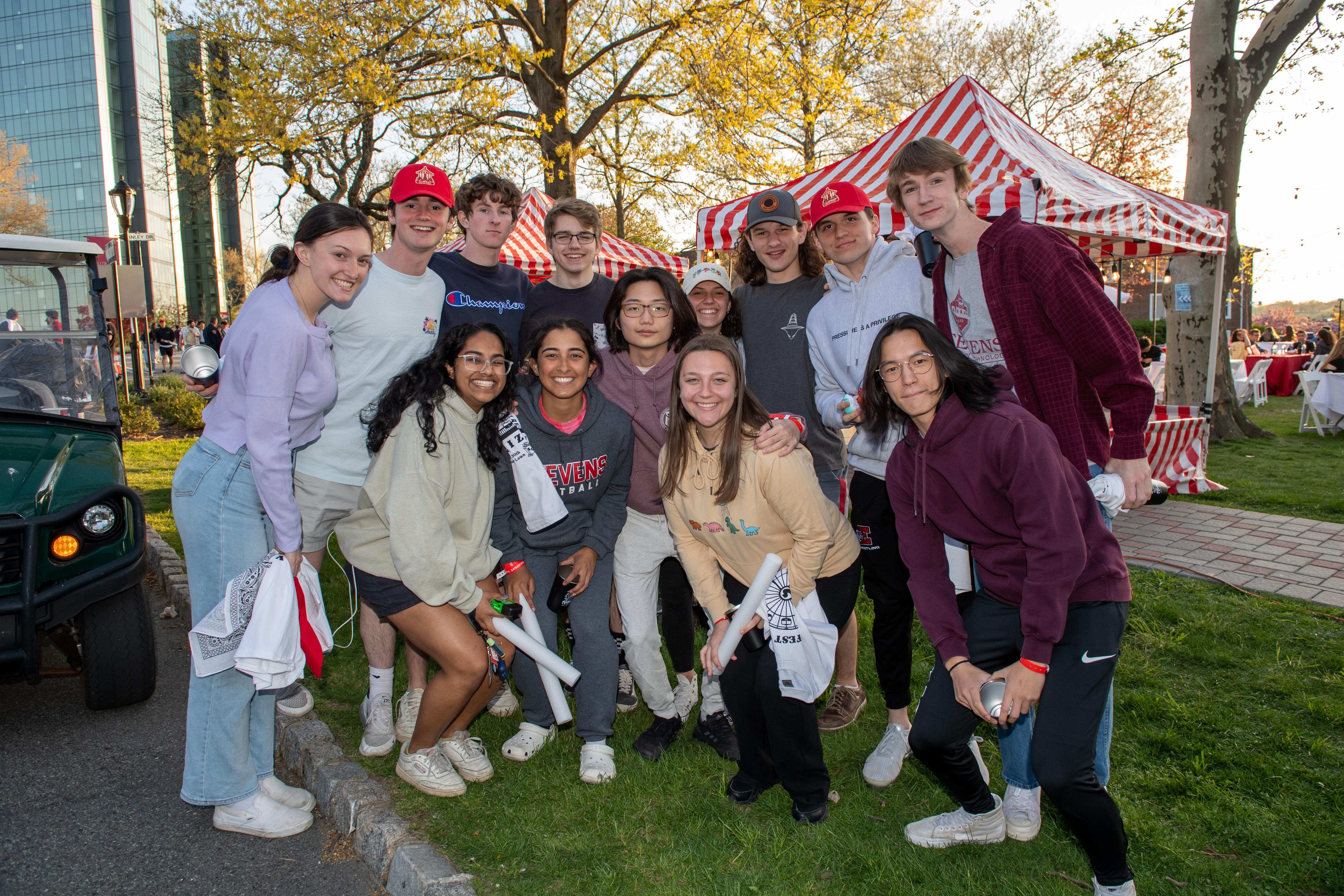 Group of students pose together for the camera at a festival on campus.