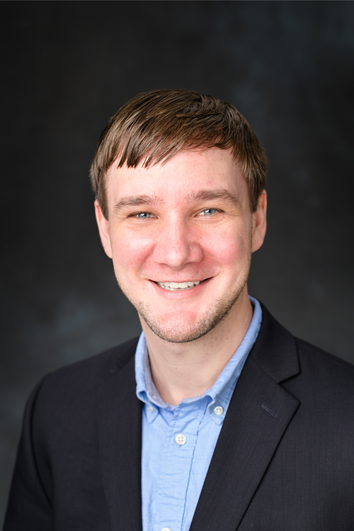 Professional headshot portrait of Adam Overig