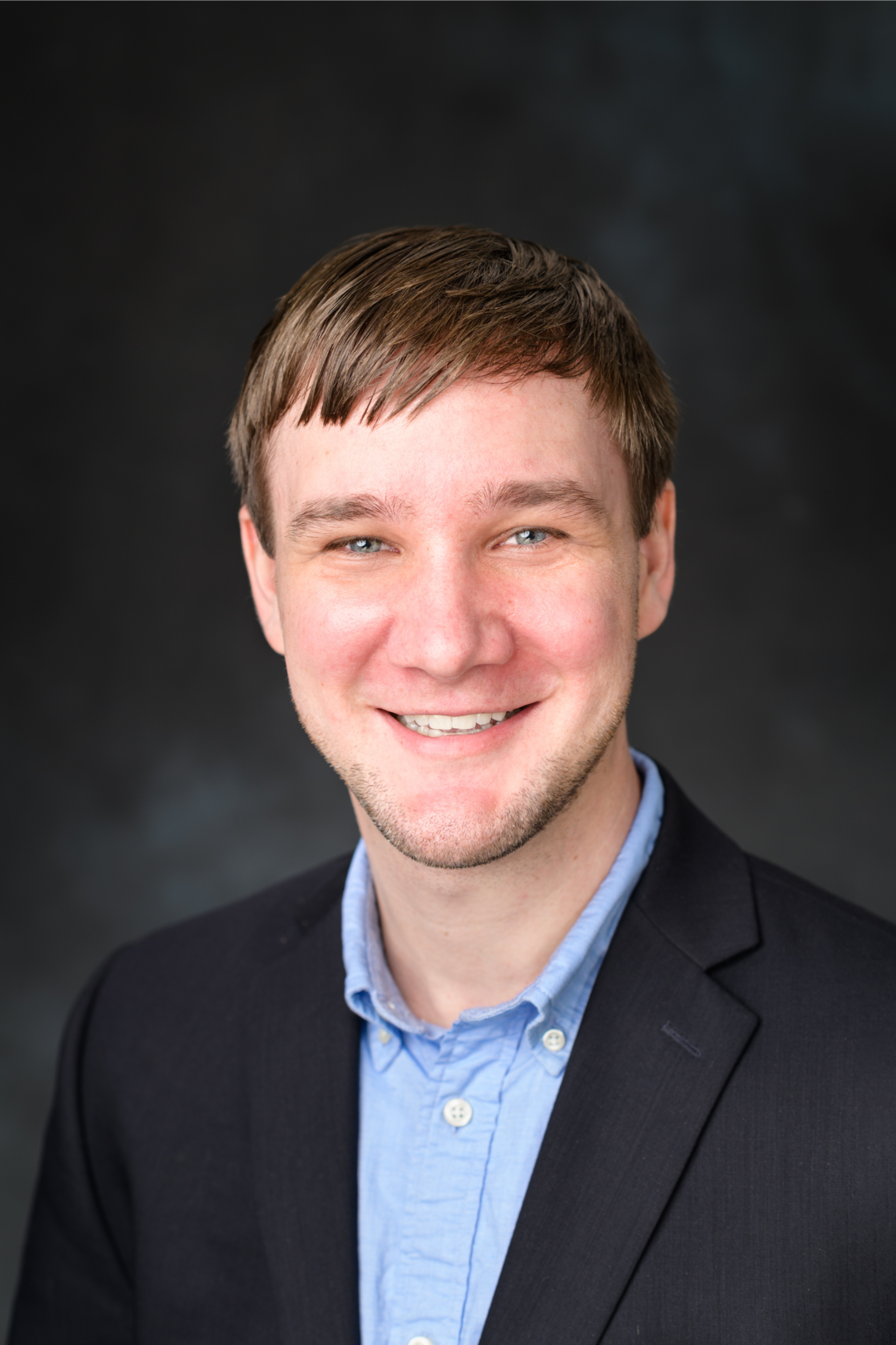 Professional headshot portrait of Adam Overig