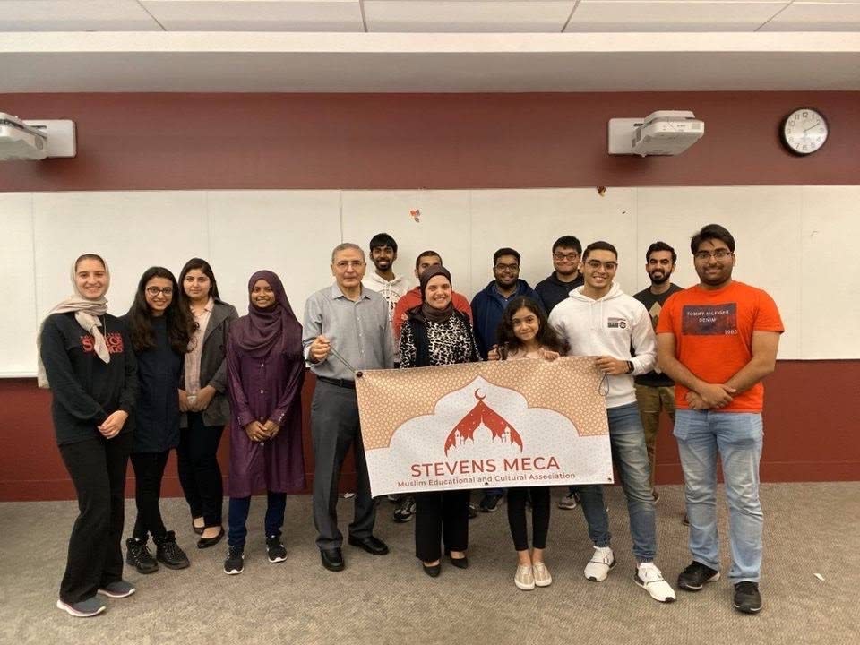 Group of students with Stevens MECA banner