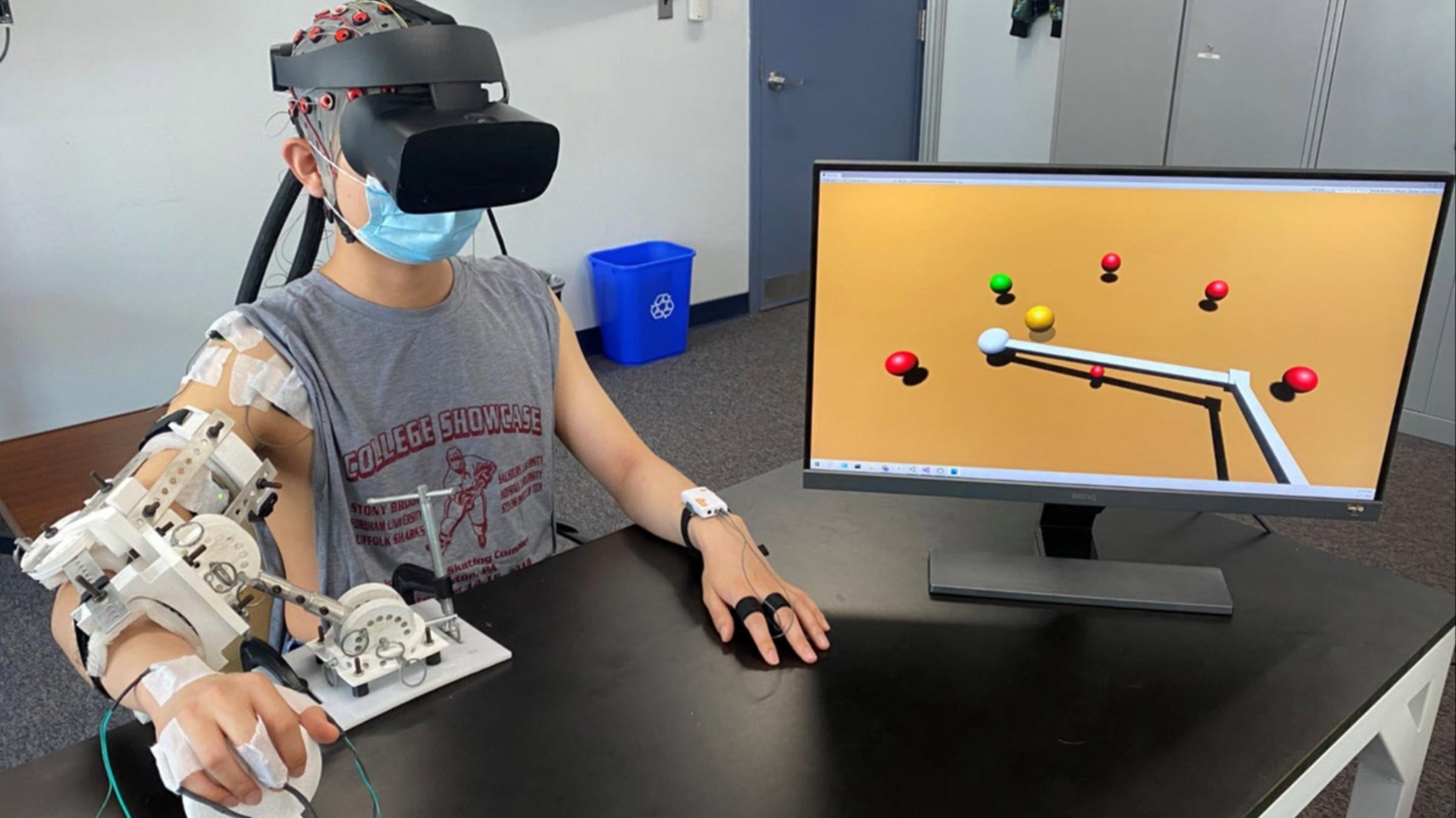 A student connected to a computer with cords and virtual reality goggles