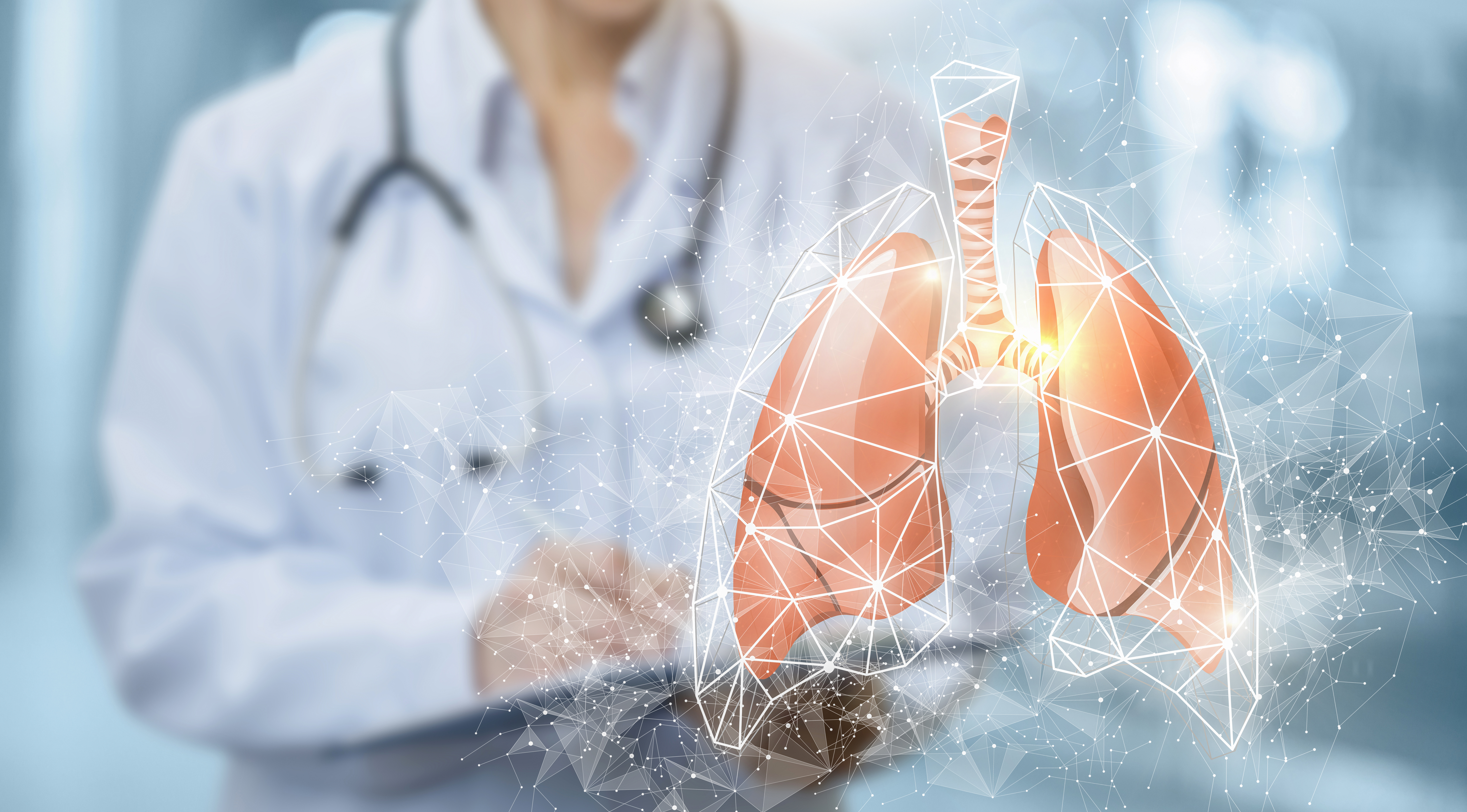 An illustration of lungs with a blurred out physician standing behind them