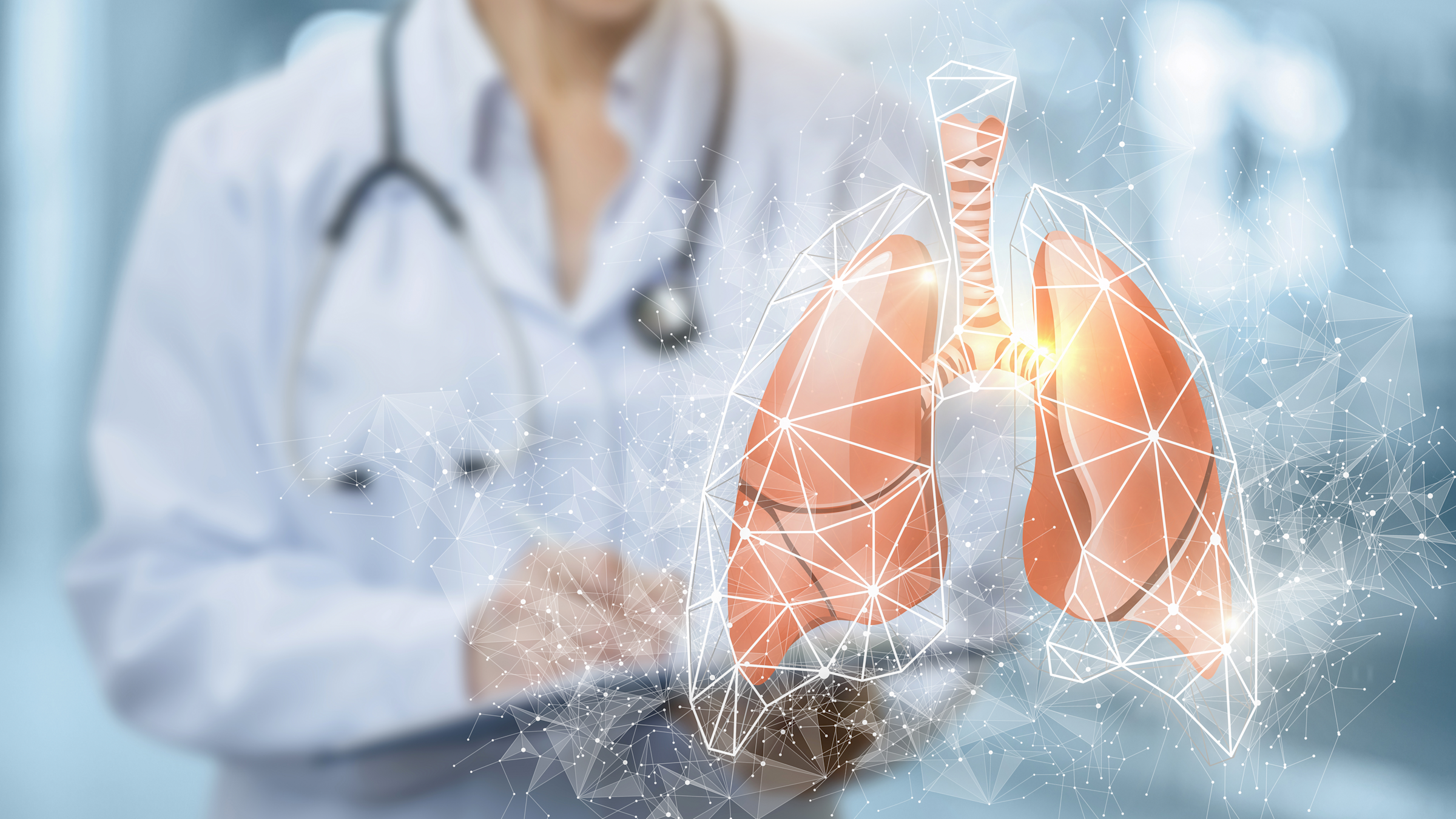 An illustration of lungs with a blurred out physician standing behind them