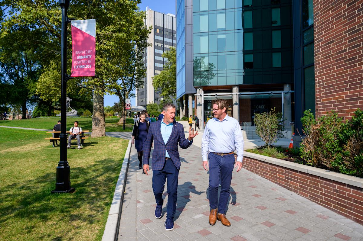 Greg Townsend walks with New Jersey State Senator Andrew Zwicker on campus.