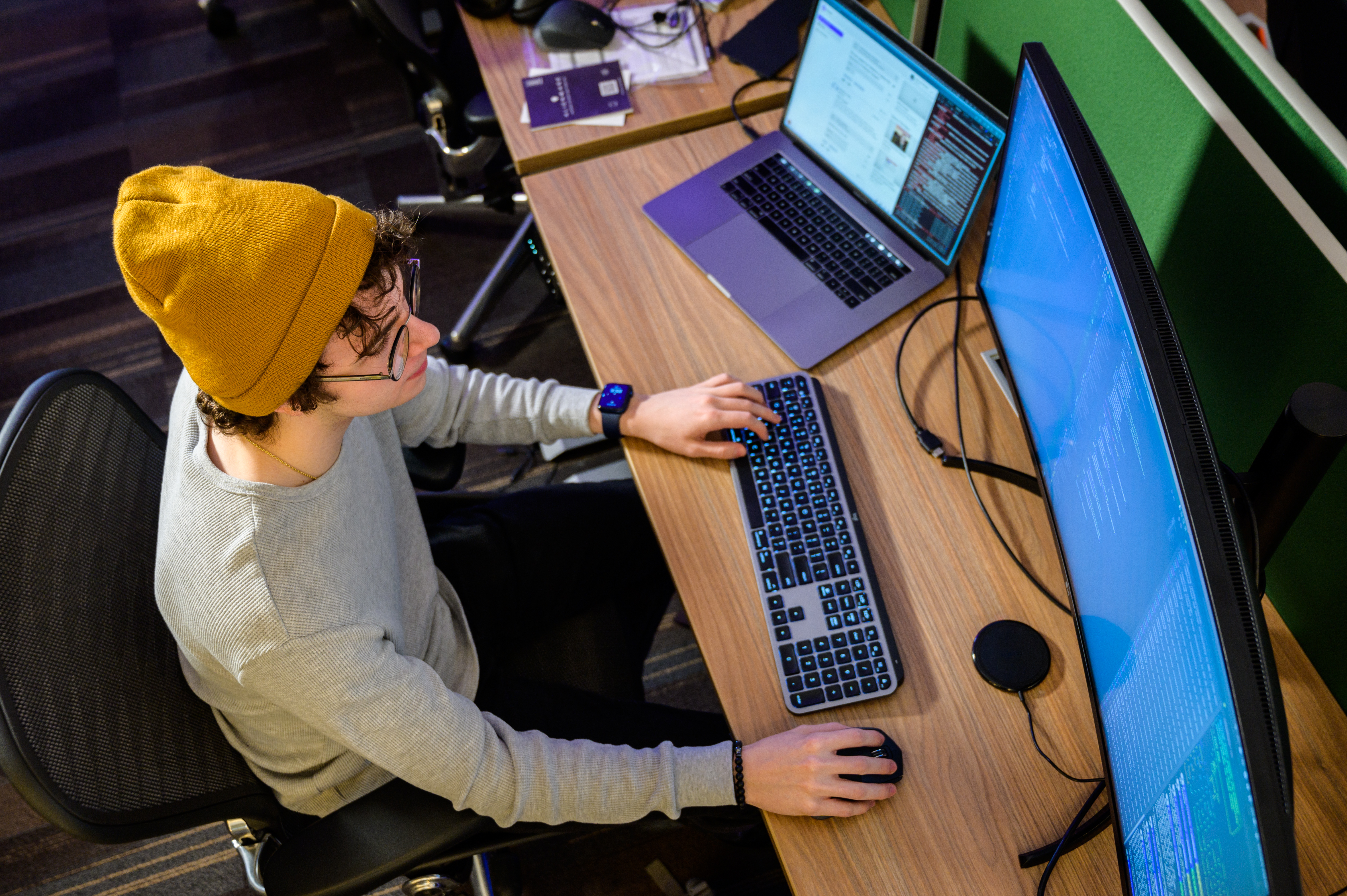 Top down view of a student working on a desktop computer.