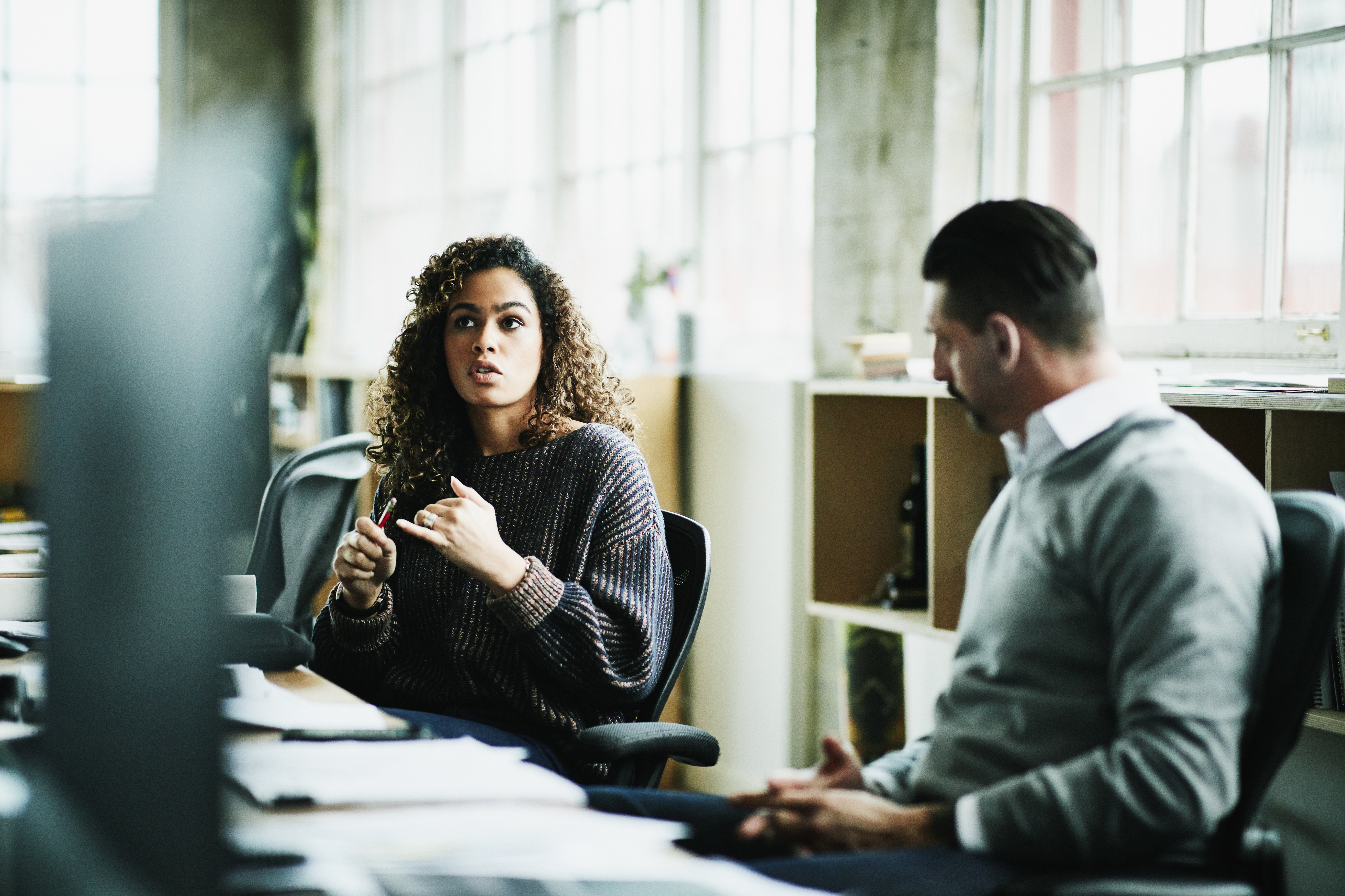 Woman and man at long desk