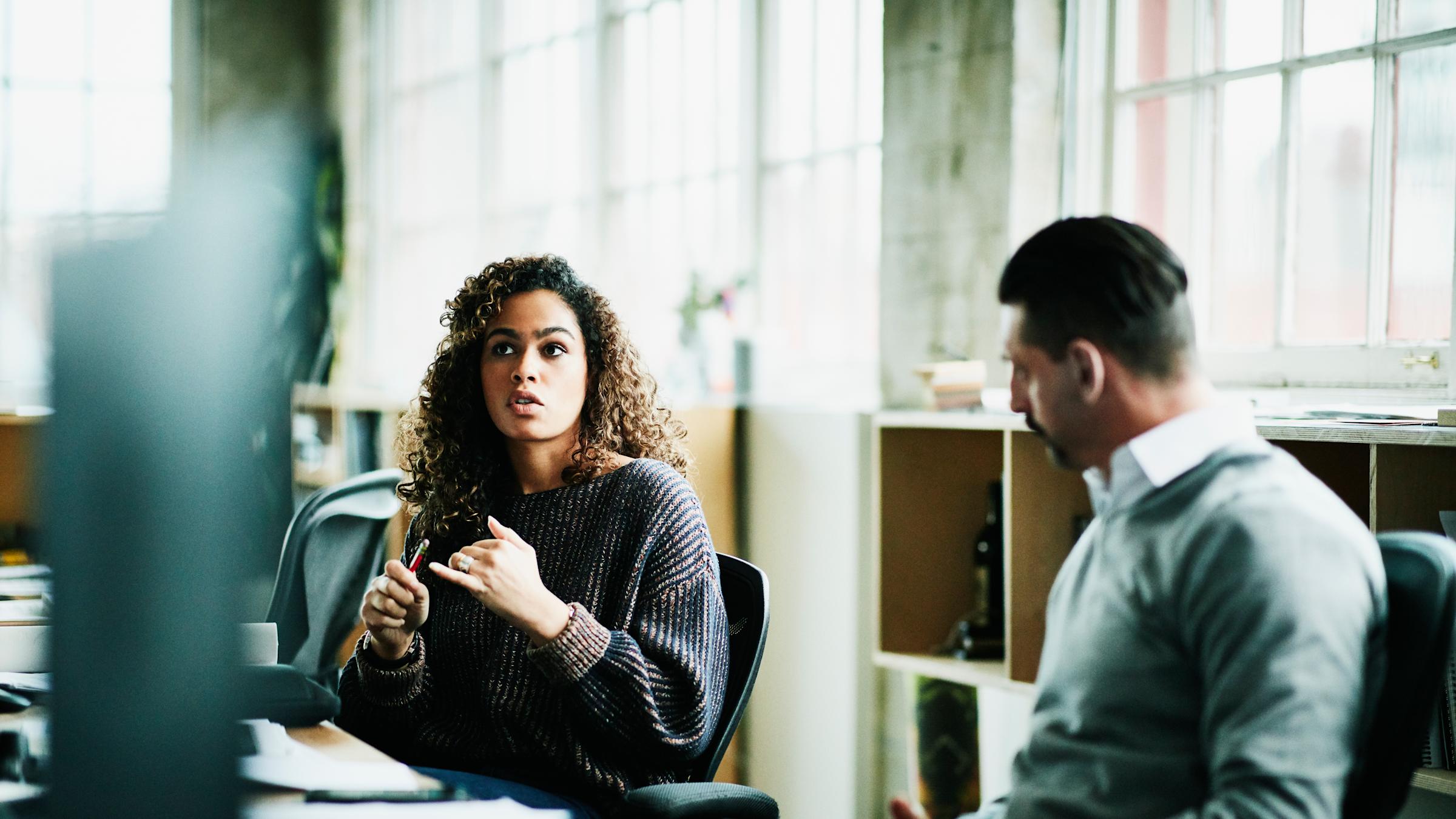 Woman and man at long desk