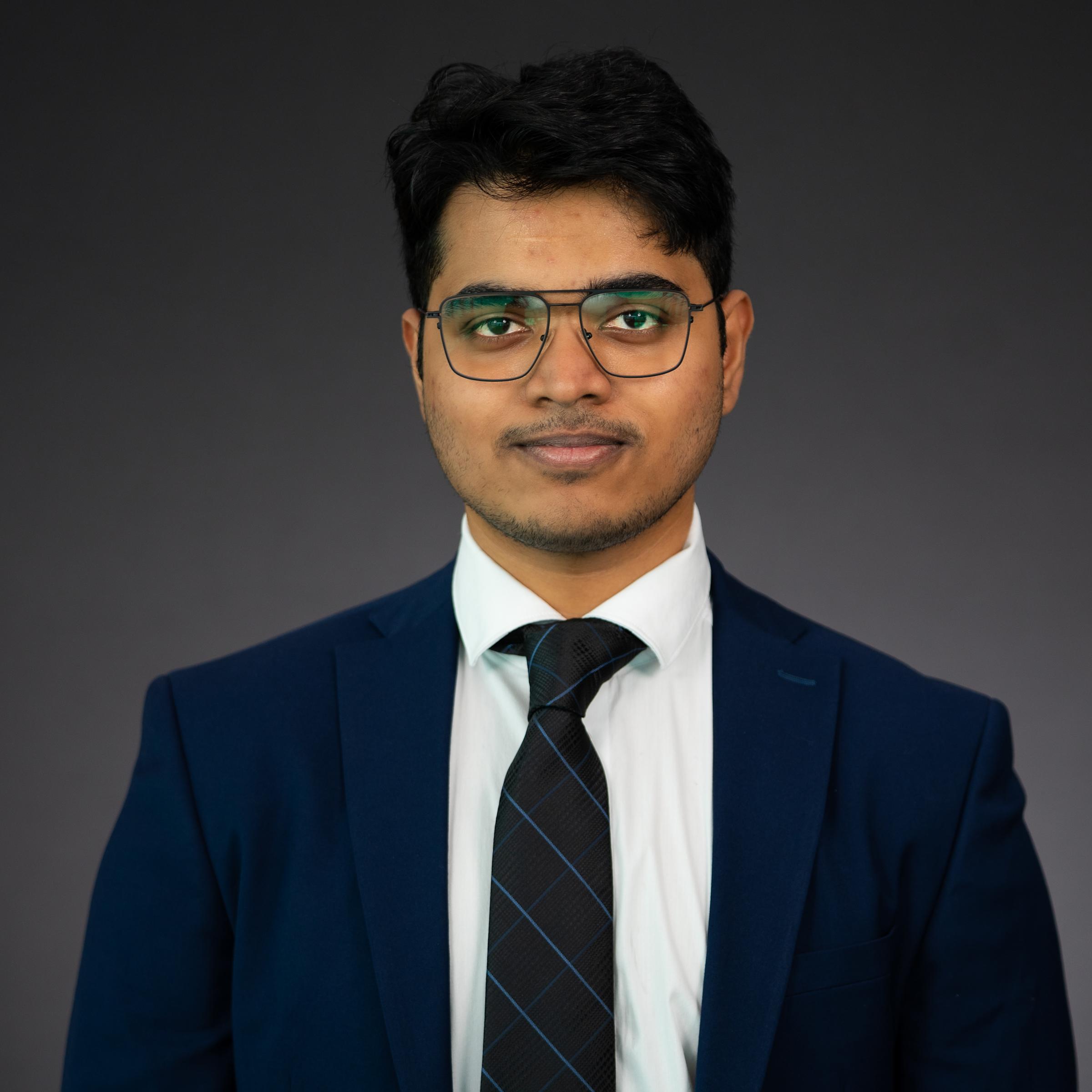 Headshot of Vedant Vijay Shinde wearing professional attire.