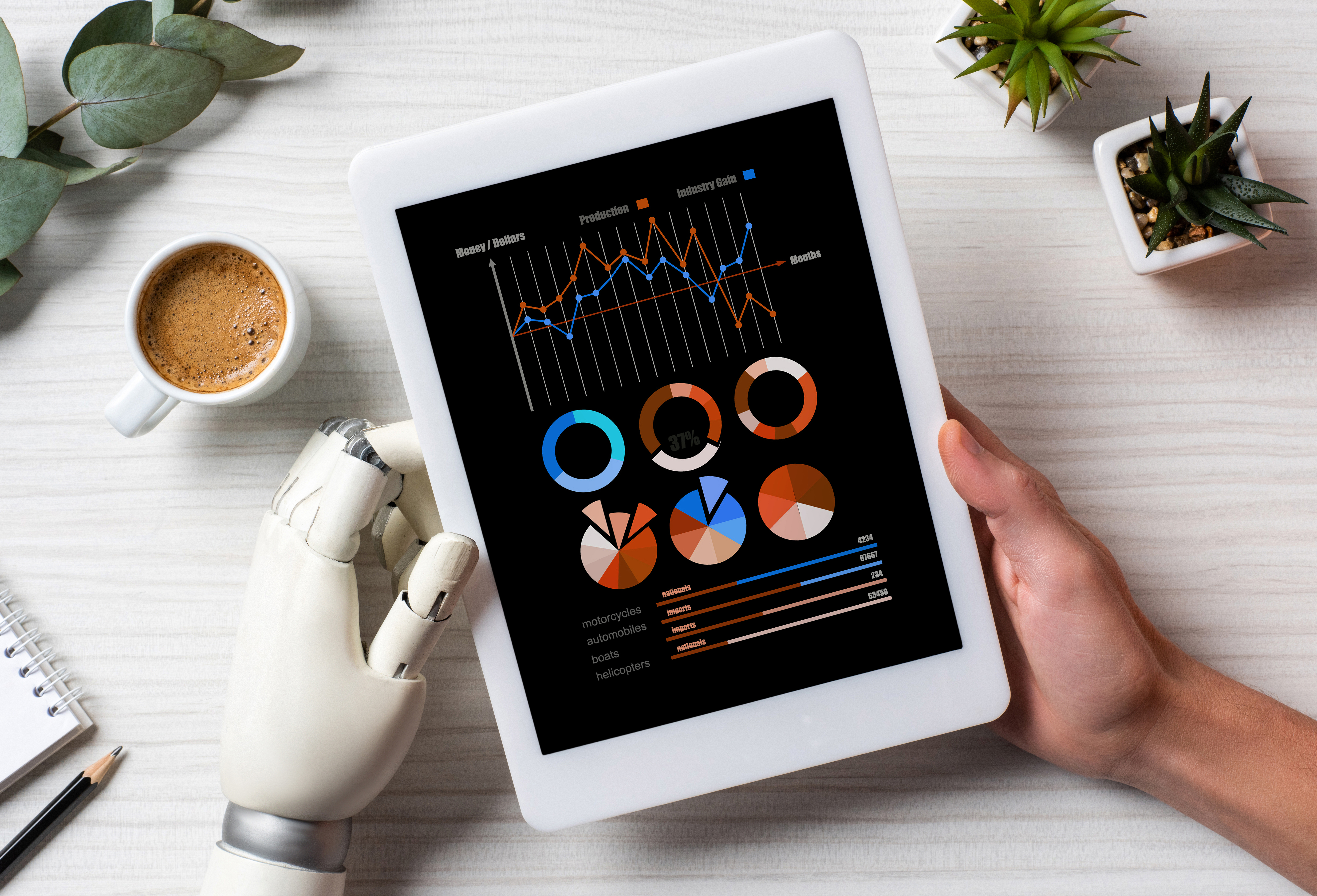 partial view of businessman with cyborg hand using digital tablet with infogrpahic on screen at