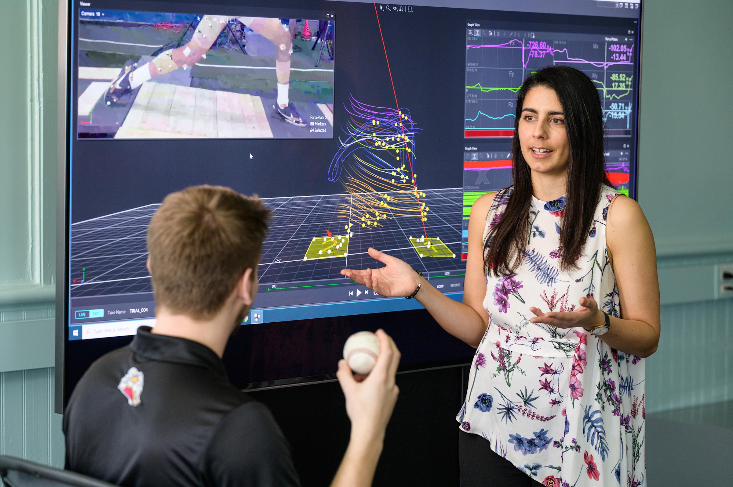 Professor Antonia Zaferiou explaining to a student her pitching research on a computer screen.