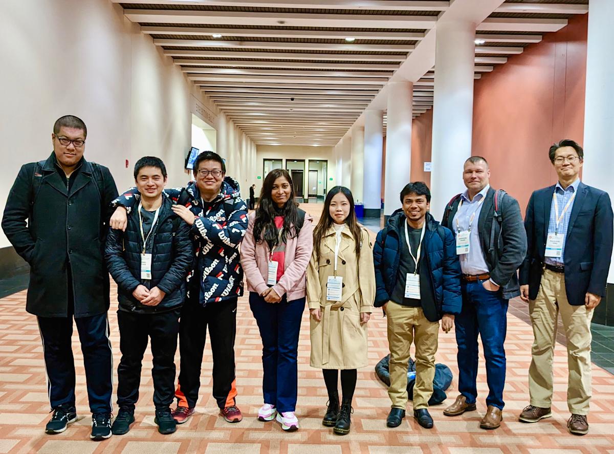 A photo of research students standing together in a lobby at the MRS Conference