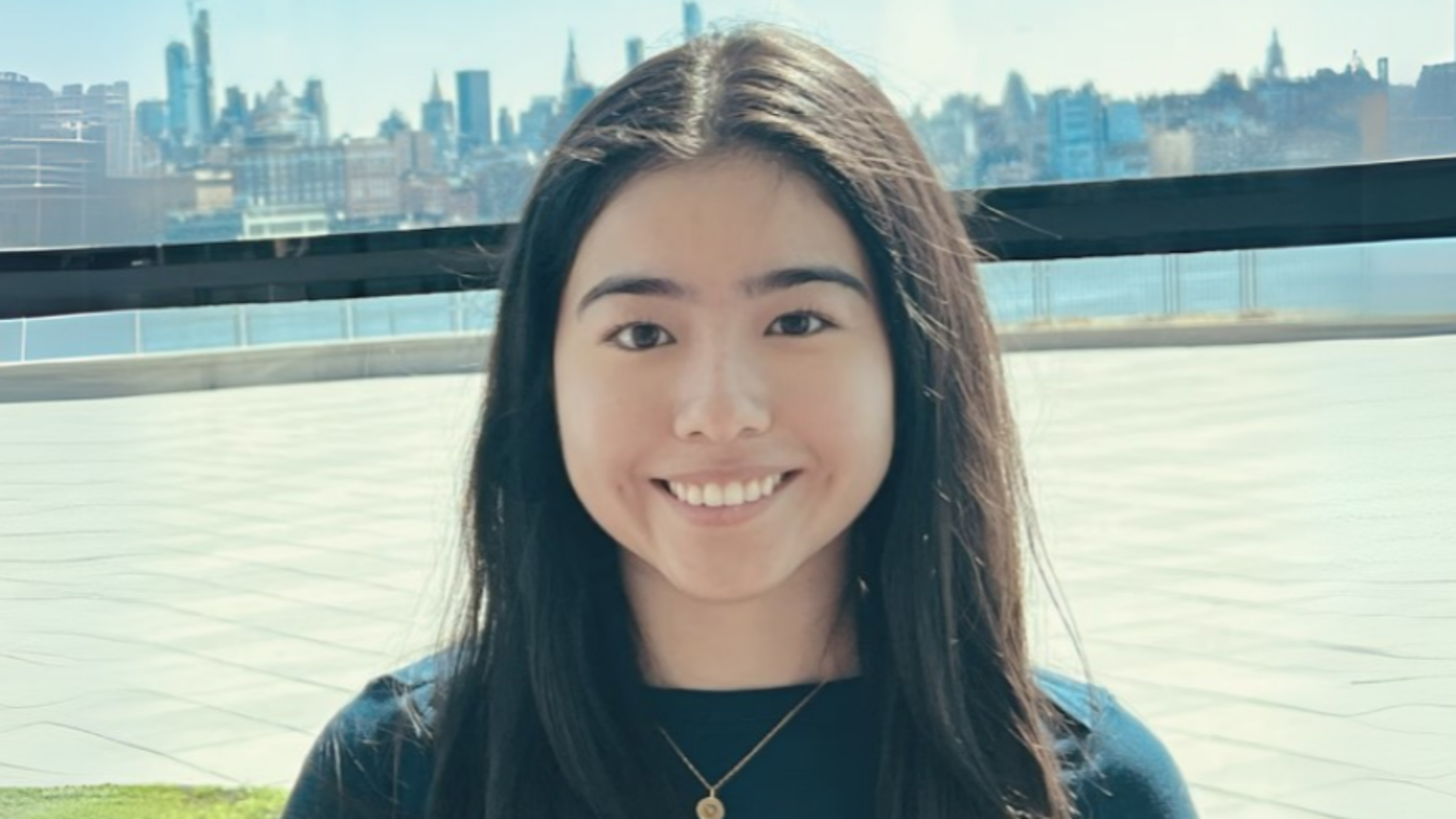 Stevens student Alexandra Garzon in the Babbio Center with Manhattan behind