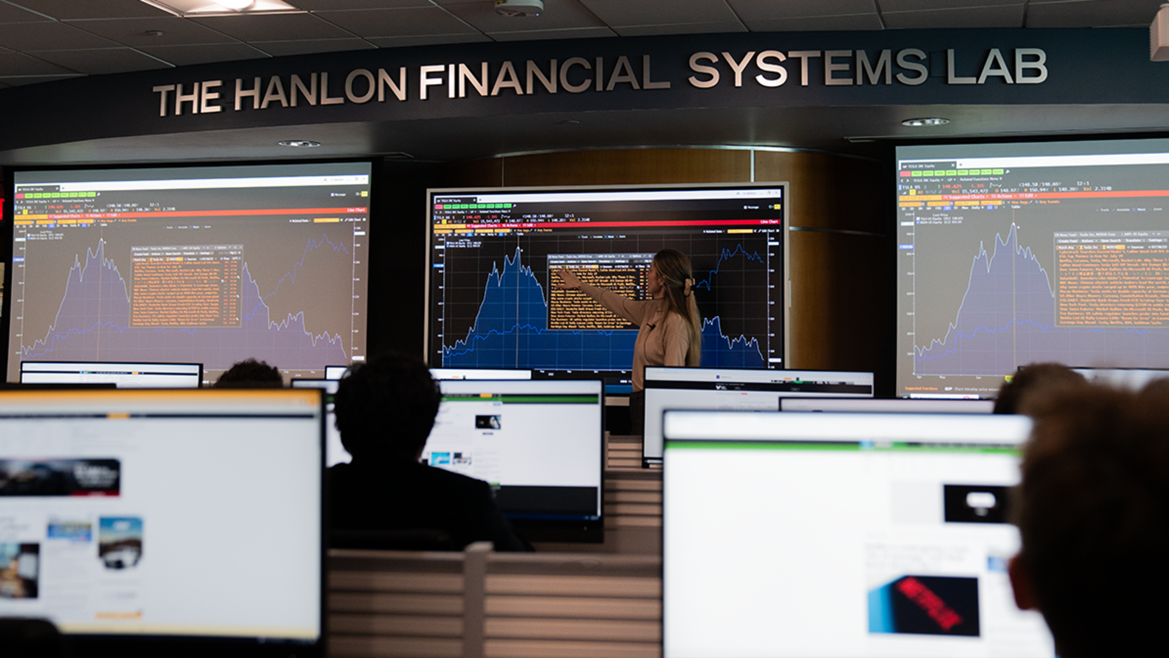 Ph.D. Student Agathe teaches a lesson in Hanlon Lab, pointing at charts on a smart screen.