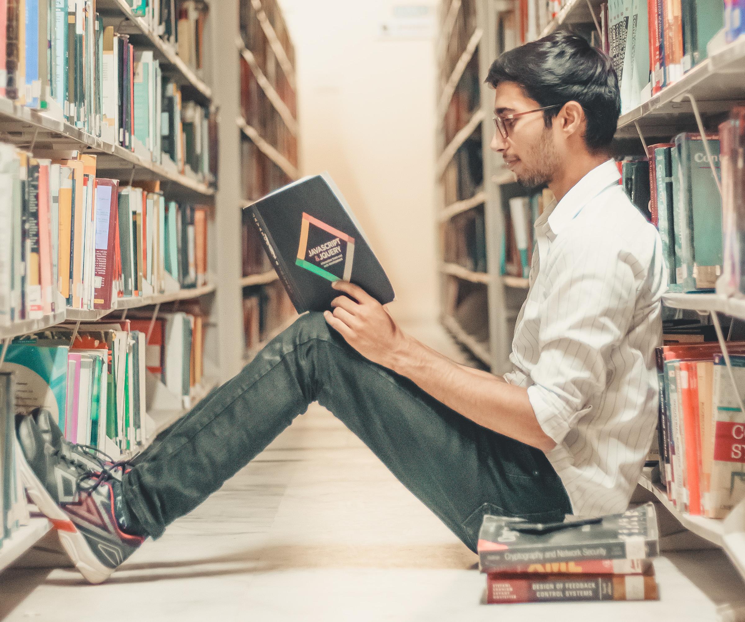student reading books in library