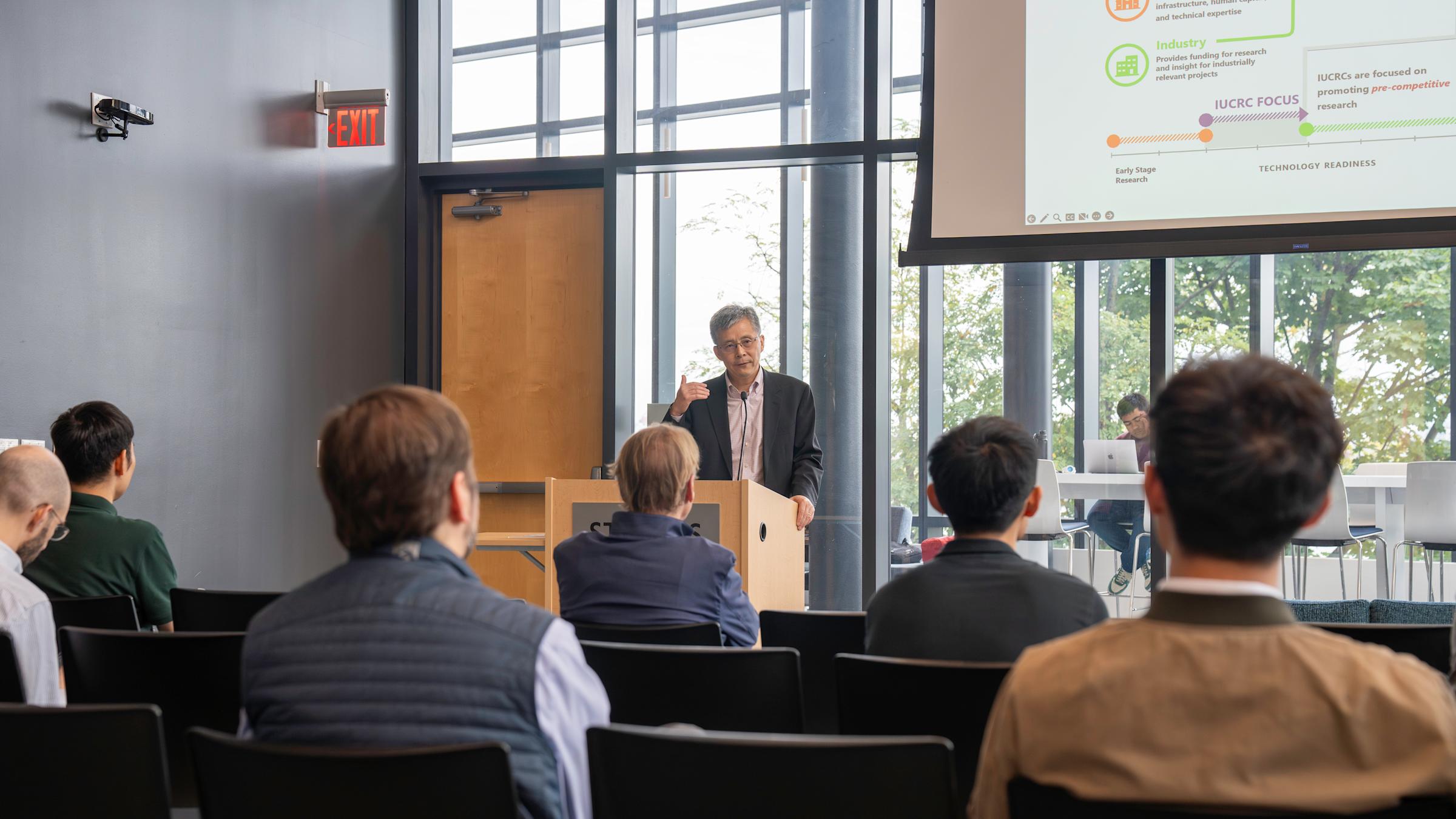 Dr. Steve Yang speaking at podium